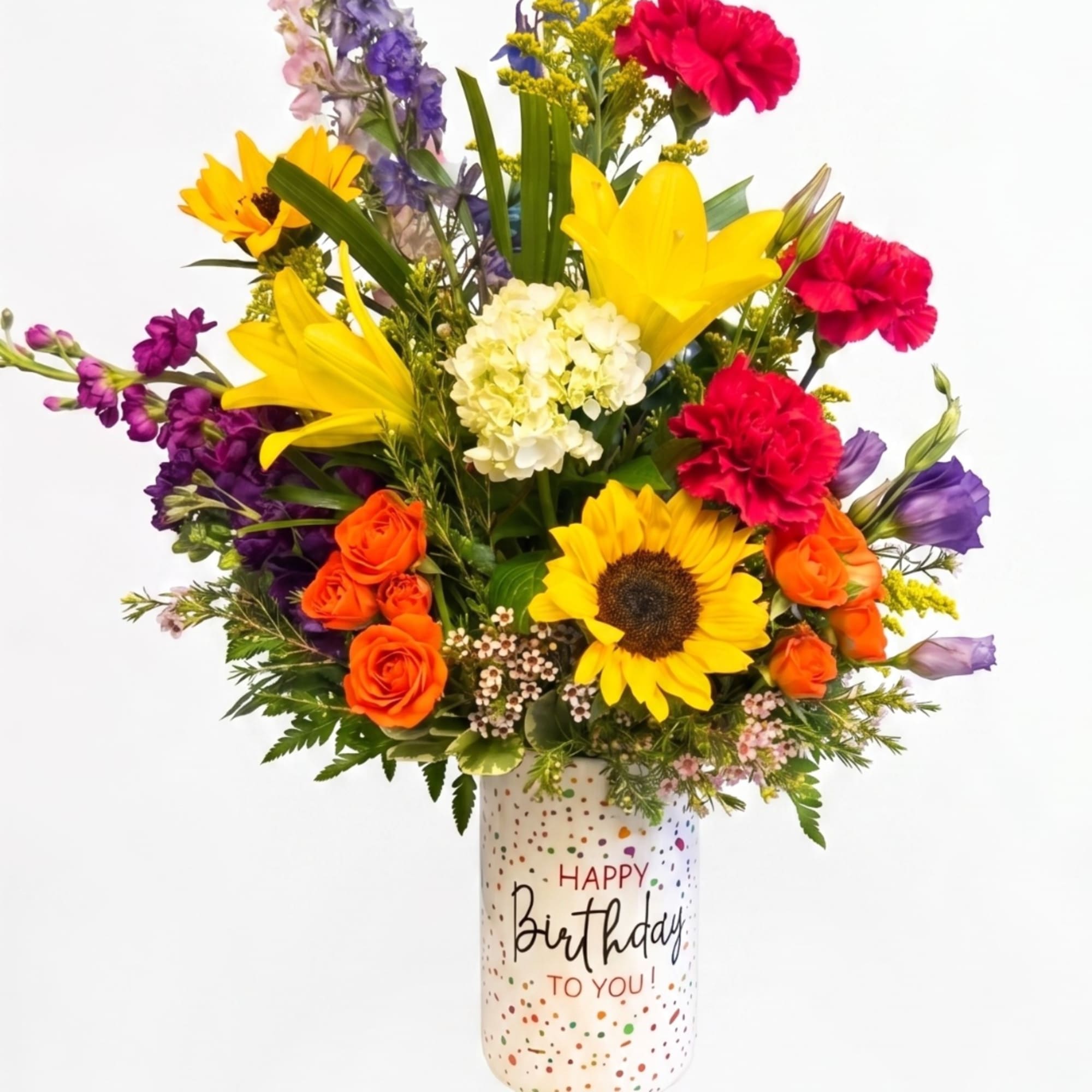 Colorful mixed bouquet in a birthday vase with sunflowers, roses, lilies, and carnations