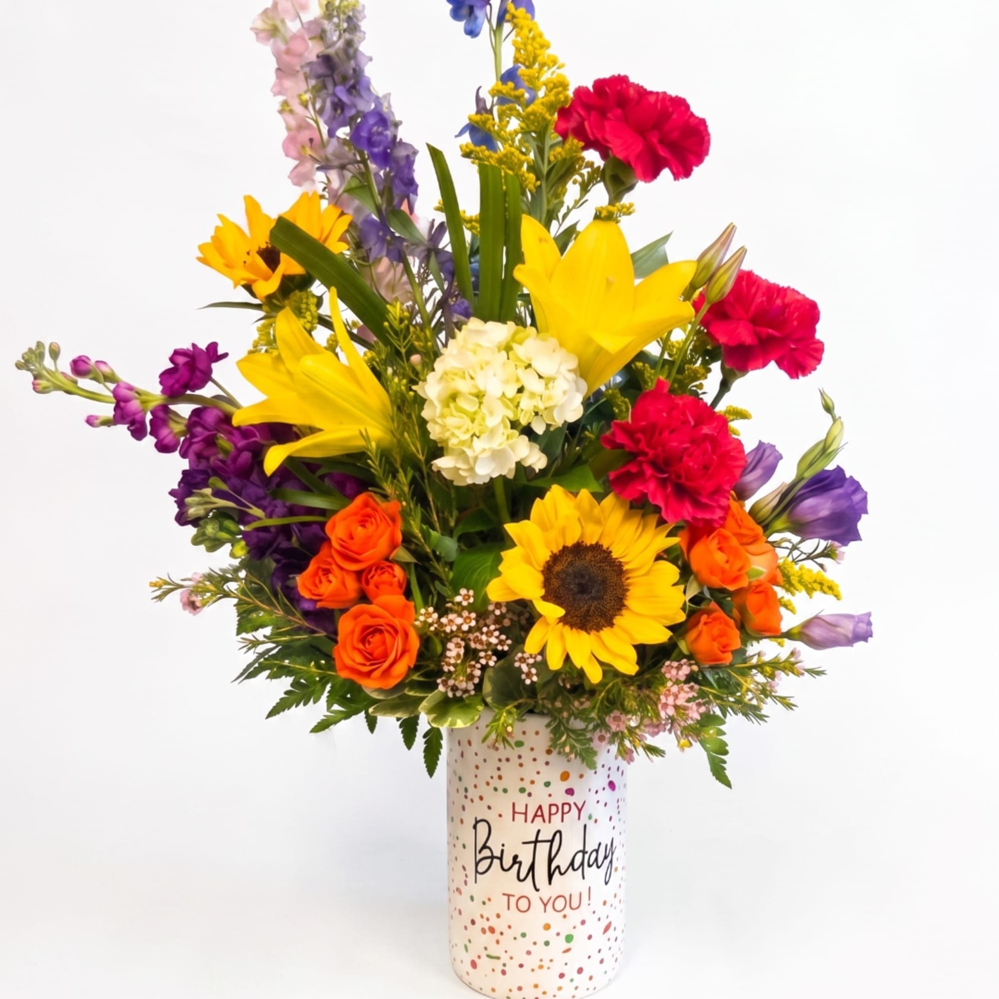 Mixed bouquet in a birthday vase with sunflowers, roses, lilies, and carnations
