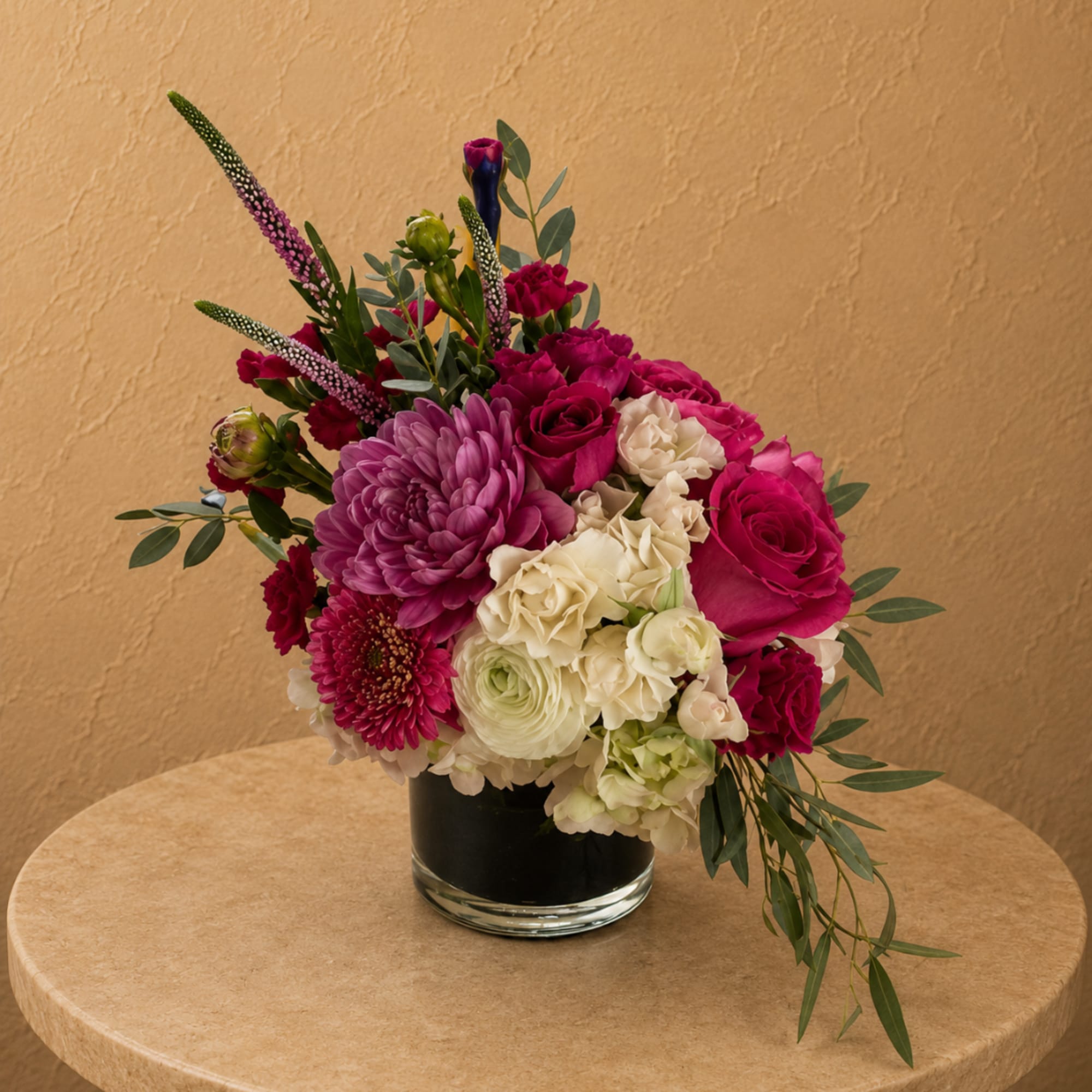 Pink and white mixed flower arrangement in a clear glass vase