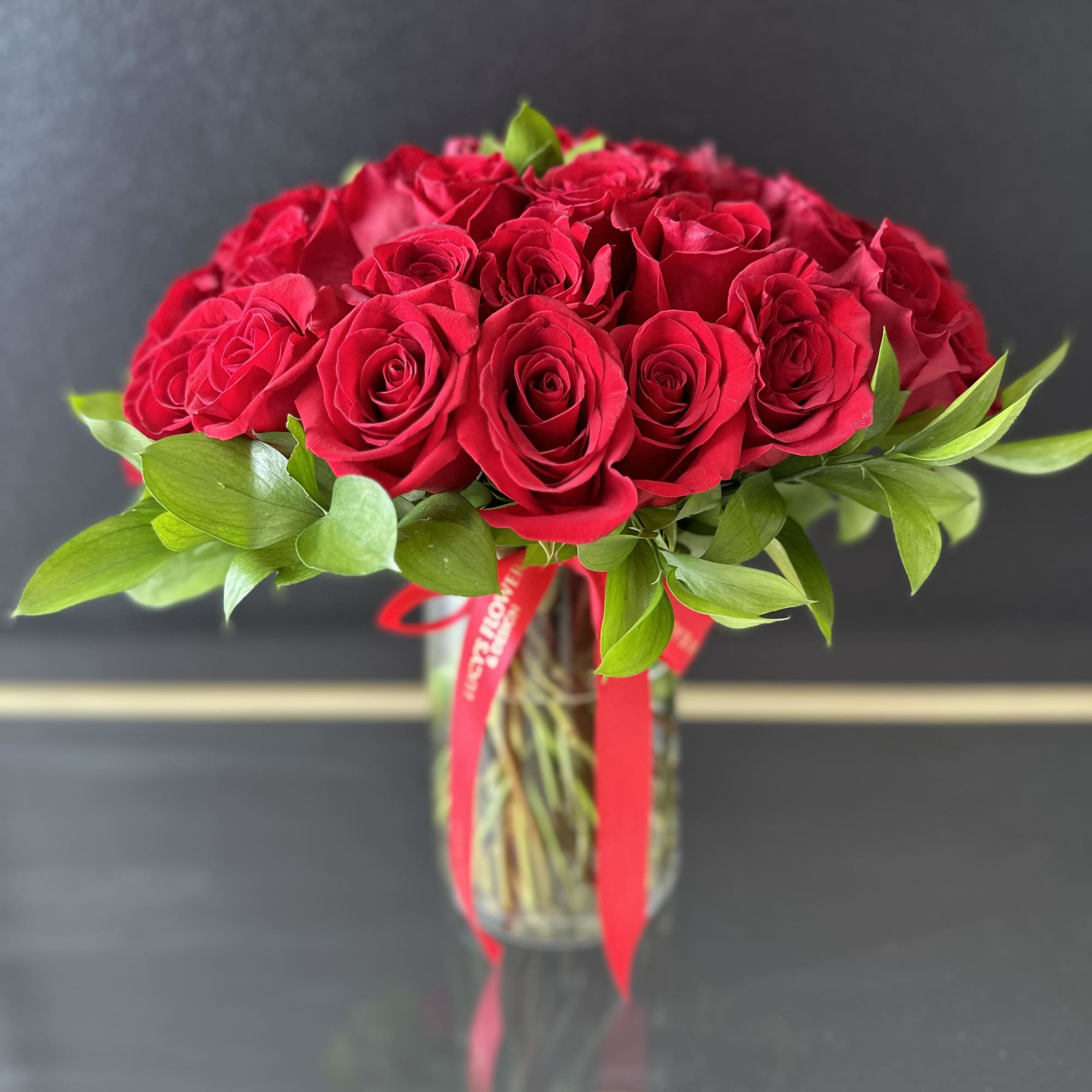  A timeless symbol of love, this stunning arrangement features 36 red