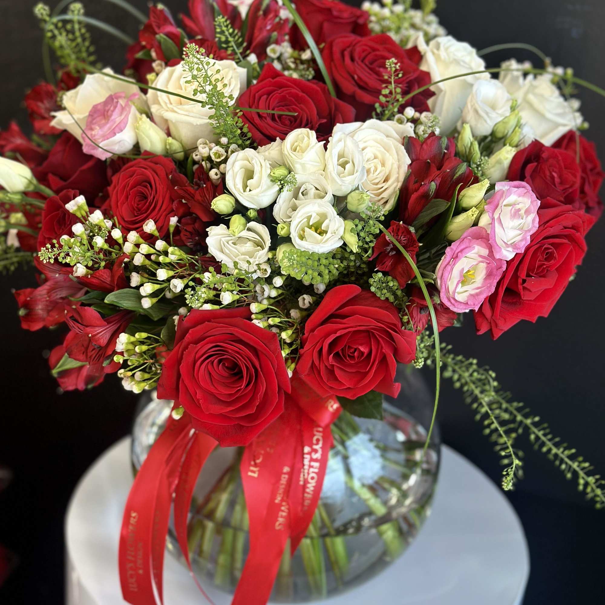 Bouquet of red and white roses in a glass vase with a red ribbon, photo 2 of 2