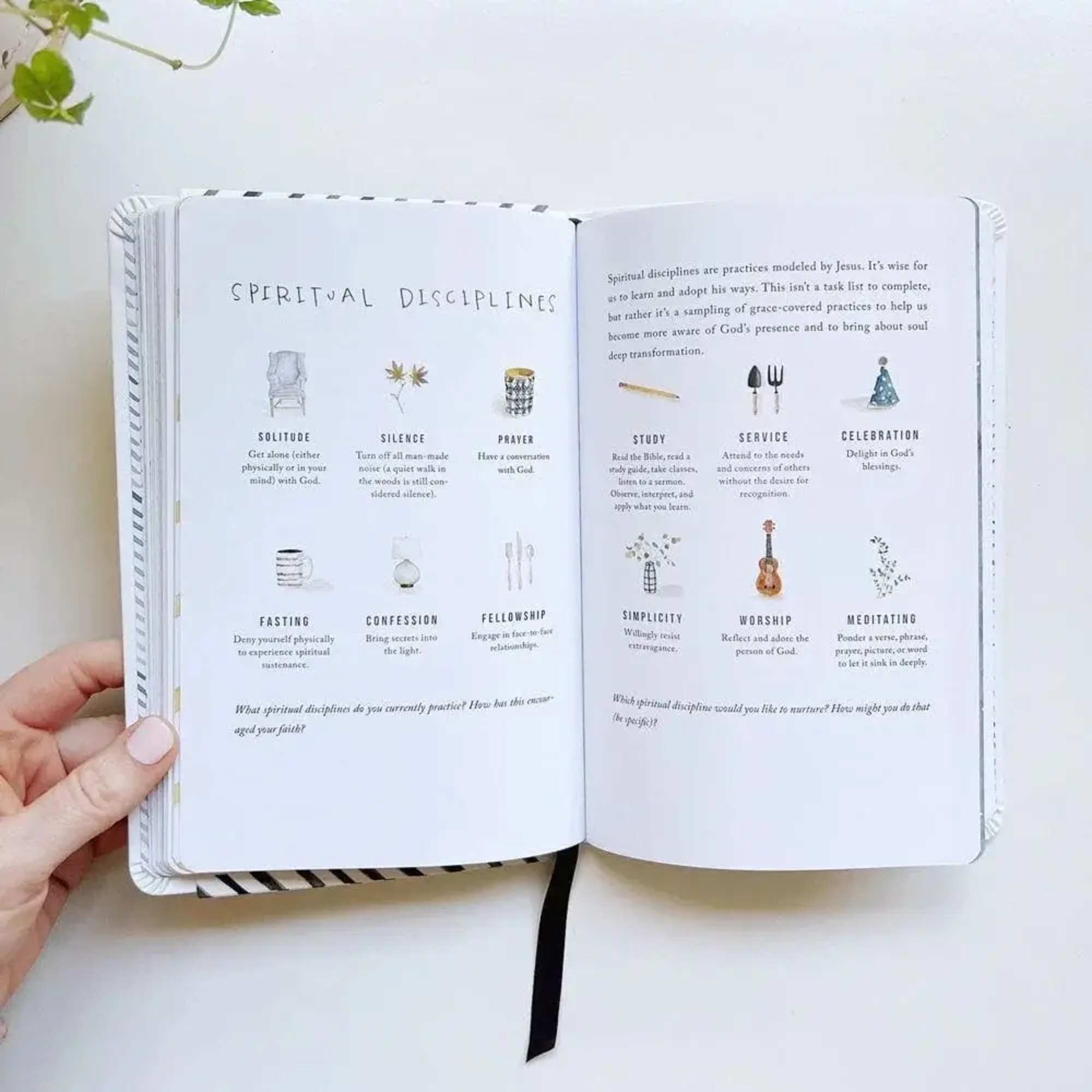 Open book with illustrated spiritual disciplines pages