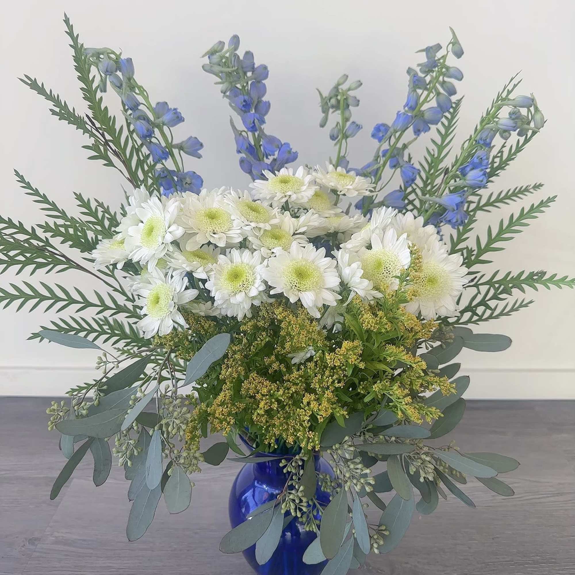 This tall blue and white arrangement is a breezy breath of summer
