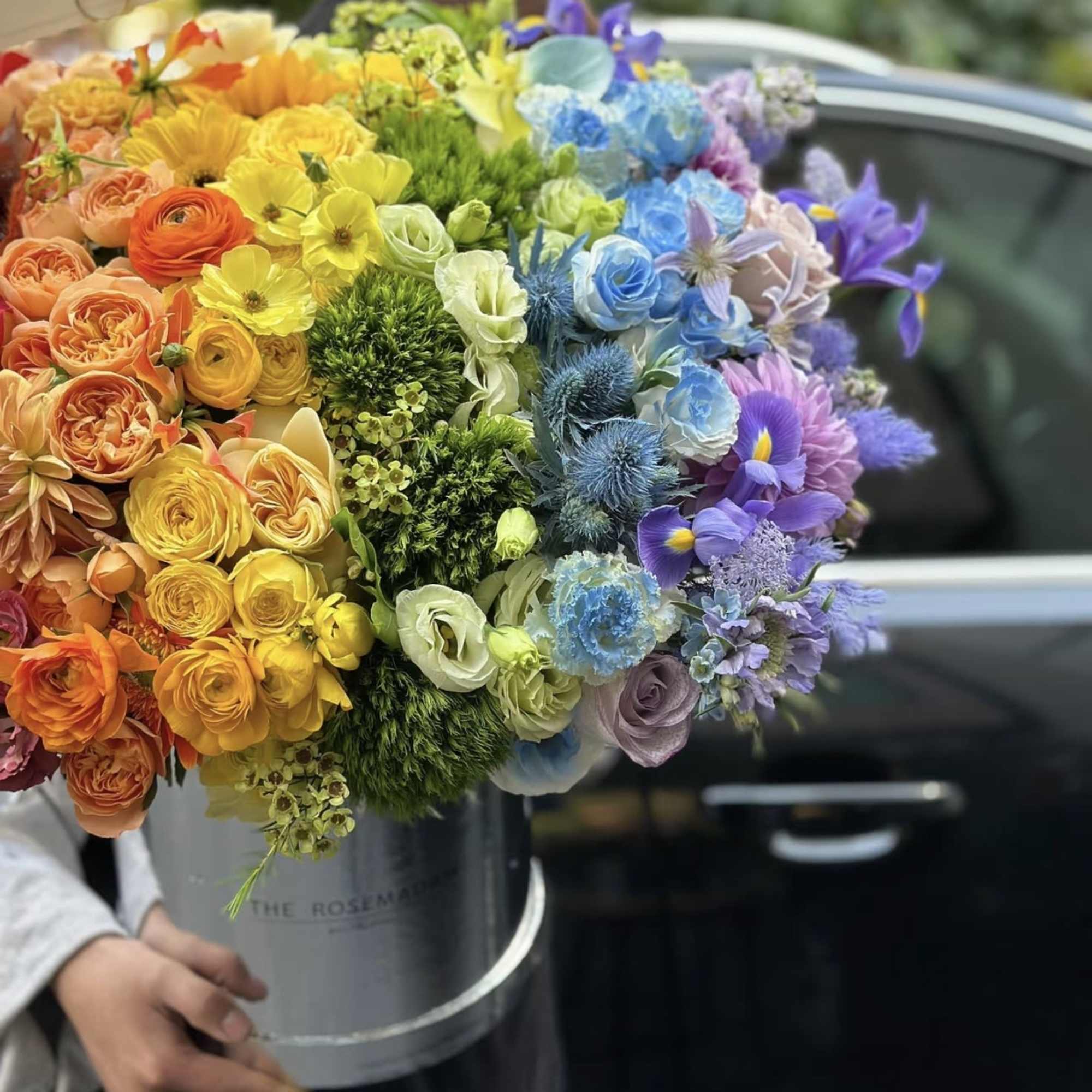 Large multicolor bouquet in a gray hatbox