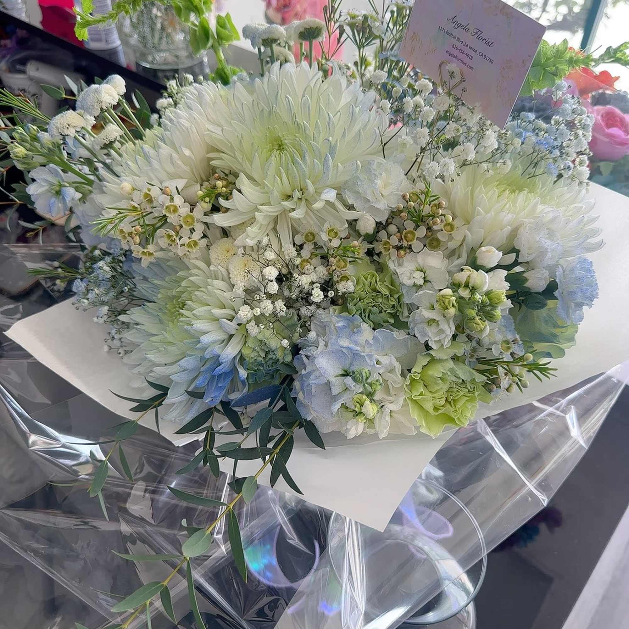 White and pale blue bouquet with large chrysanthemum blooms
