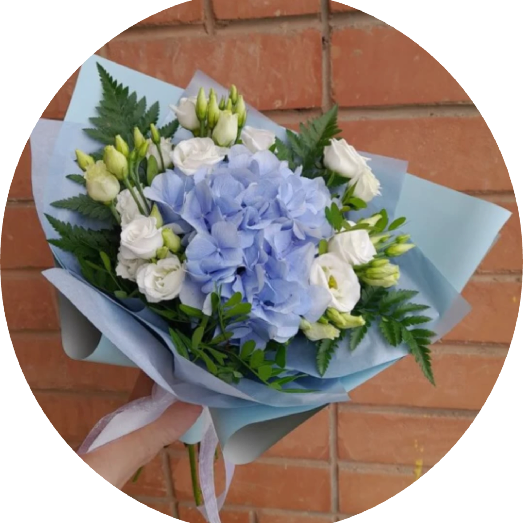 A rounded cluster of pale blue hydrangea takes center stage in this