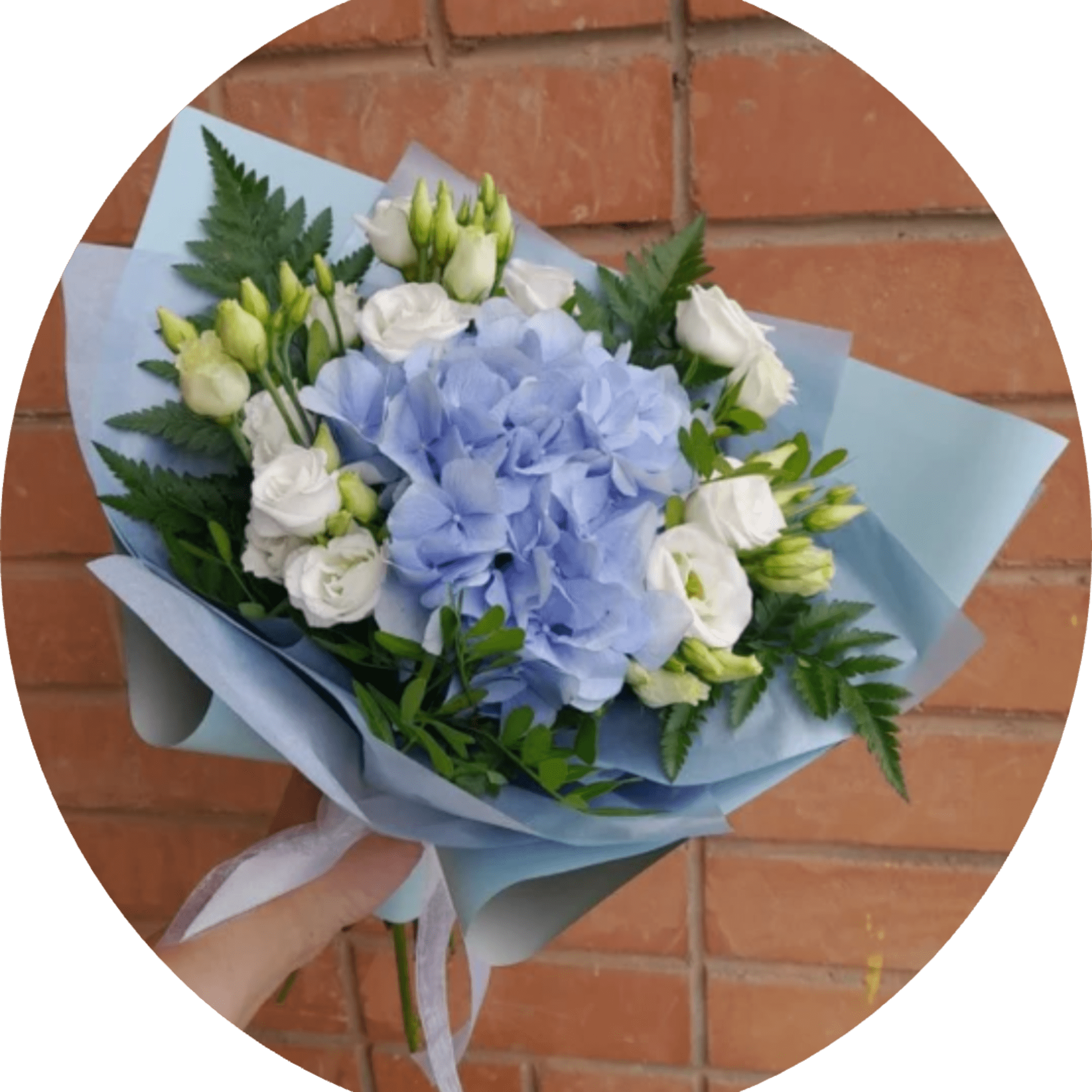 A rounded cluster of pale blue hydrangea takes center stage in this