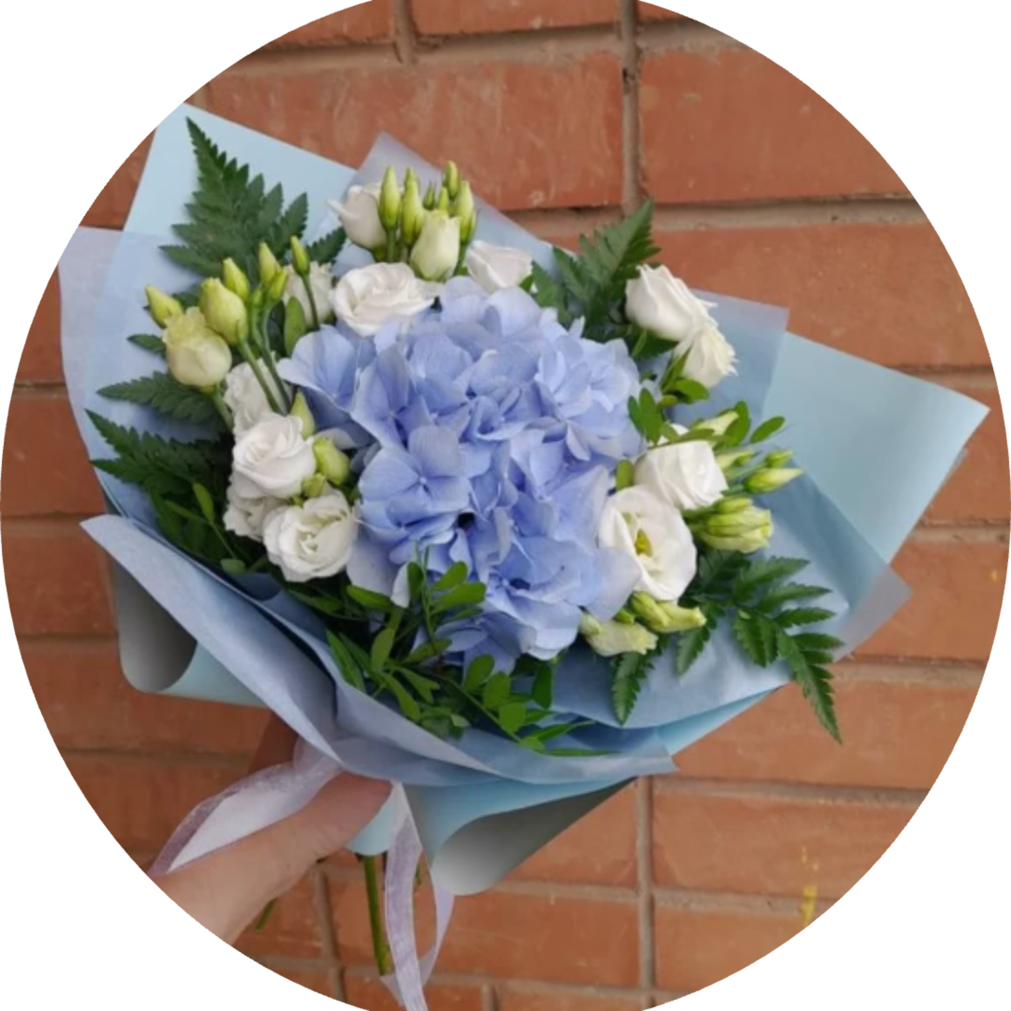 A rounded cluster of pale blue hydrangea takes center stage in this