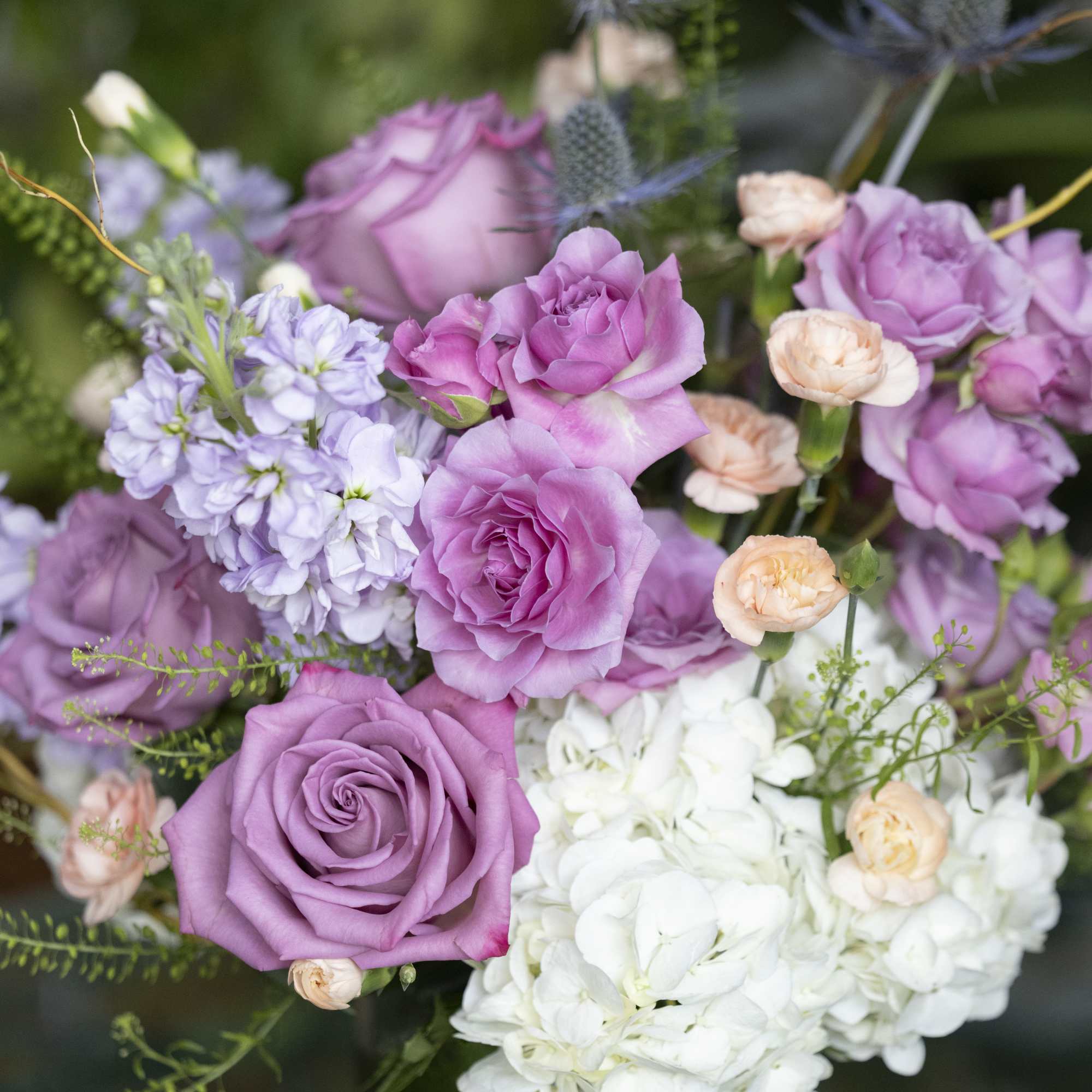 Bouquet of lavender roses, white hydrangeas, and pale peach spray roses