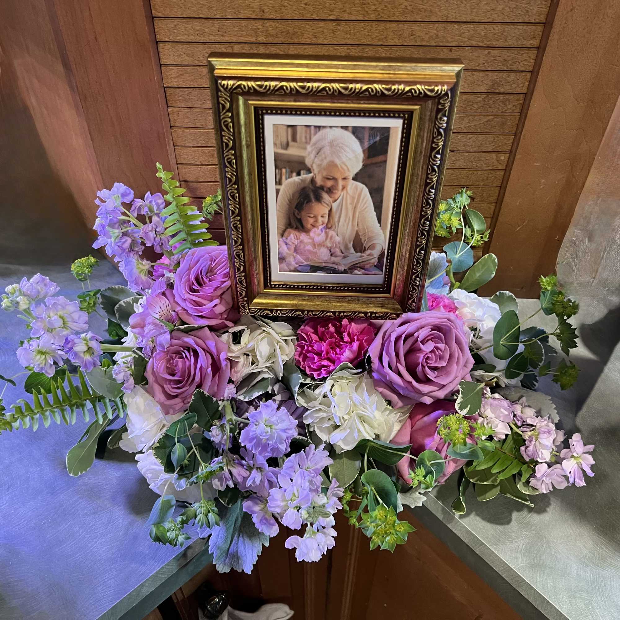 Soft lavender roses and whisper-pink blooms form a low, spreading tribute that, photo 2 of 2