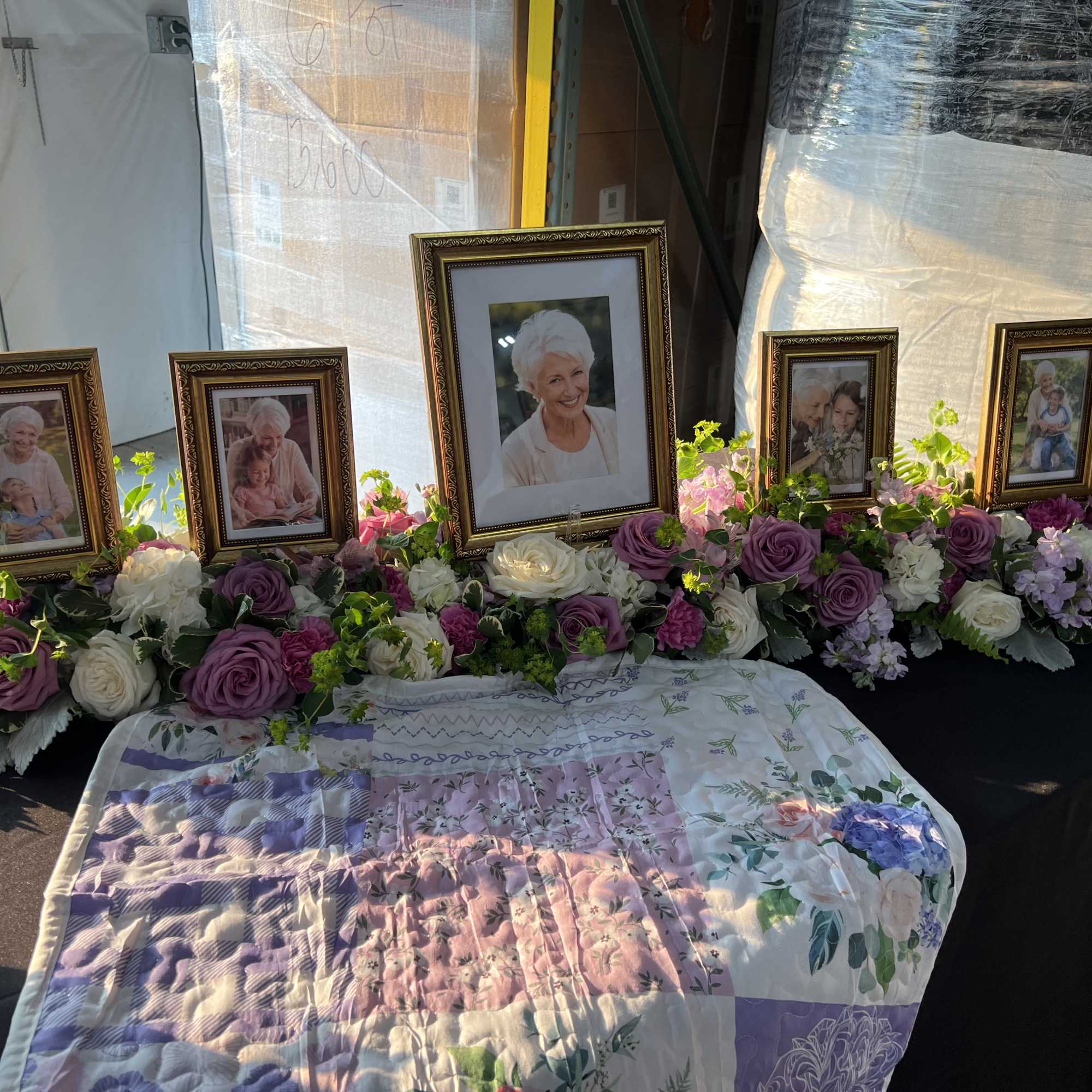 Soft lavender roses and whisper-pink blooms form a low, spreading tribute that