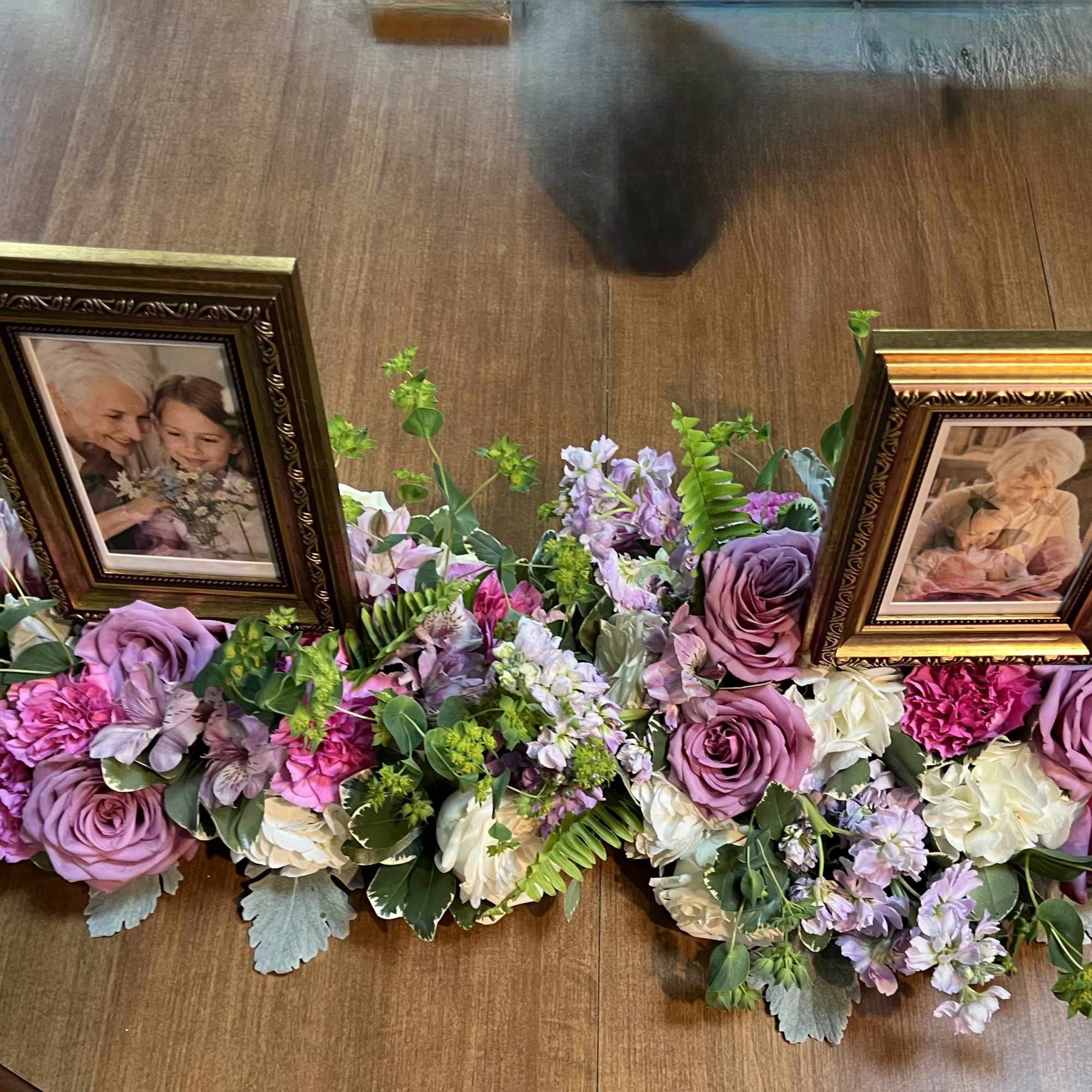 Soft lavender roses and whisper-pink blooms form a low, spreading tribute that, photo 2 of 2