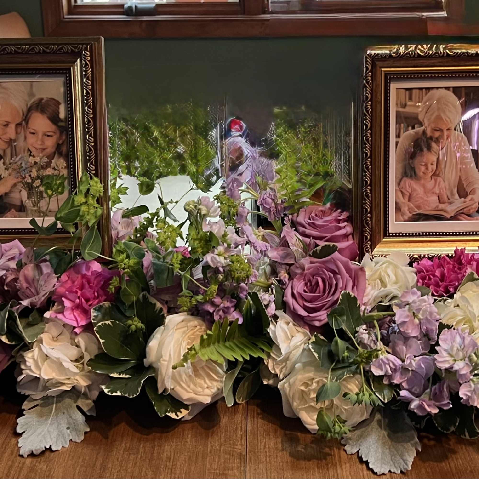 Soft lavender roses and whisper-pink blooms form a low, spreading tribute that