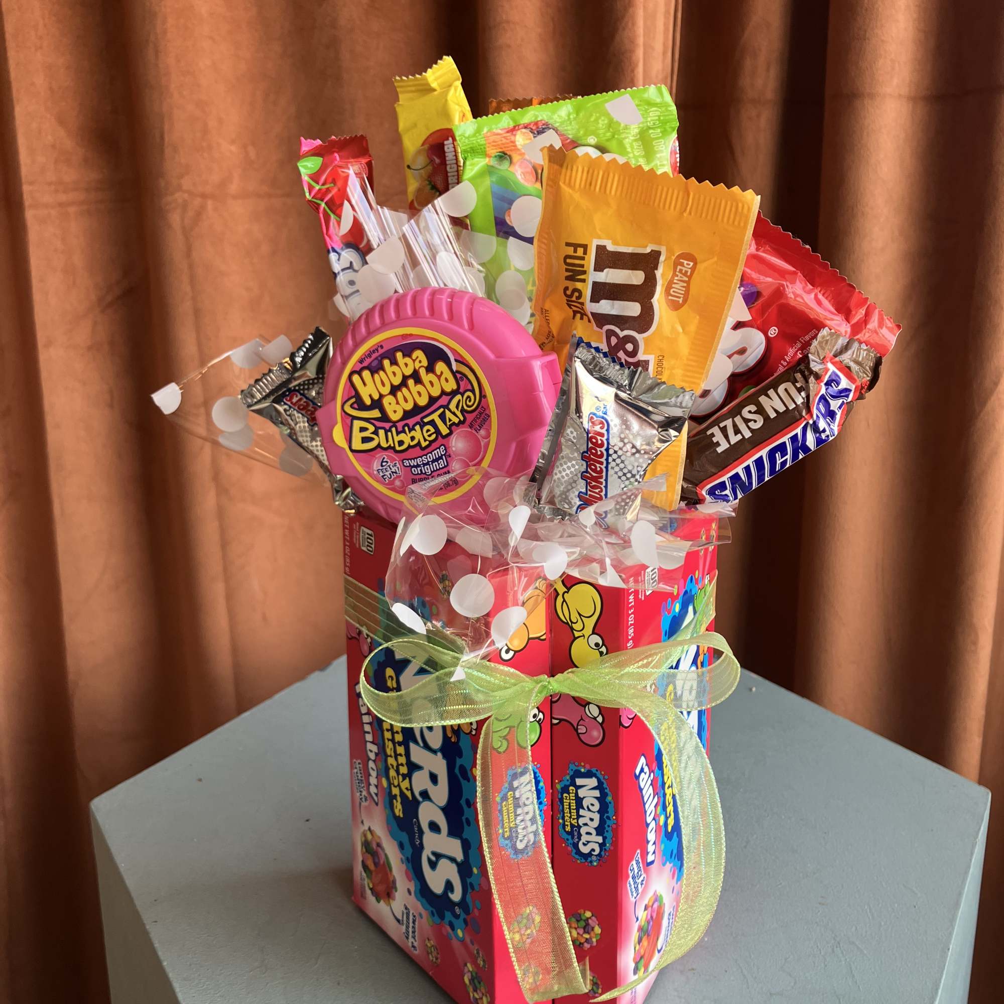 Candy gift box with assorted sweets and a ribbon bow