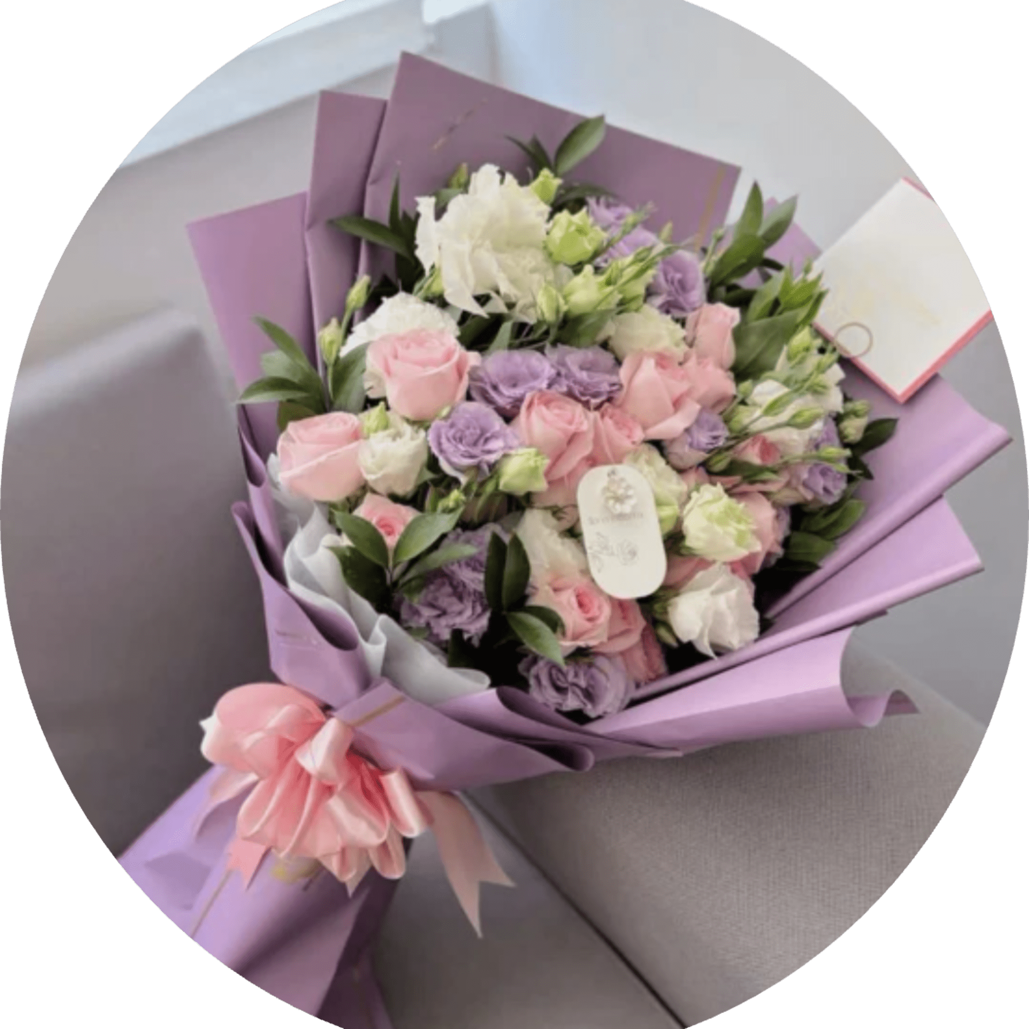 Lavender-toned blooms mingle with soft pink and creamy white roses in a
