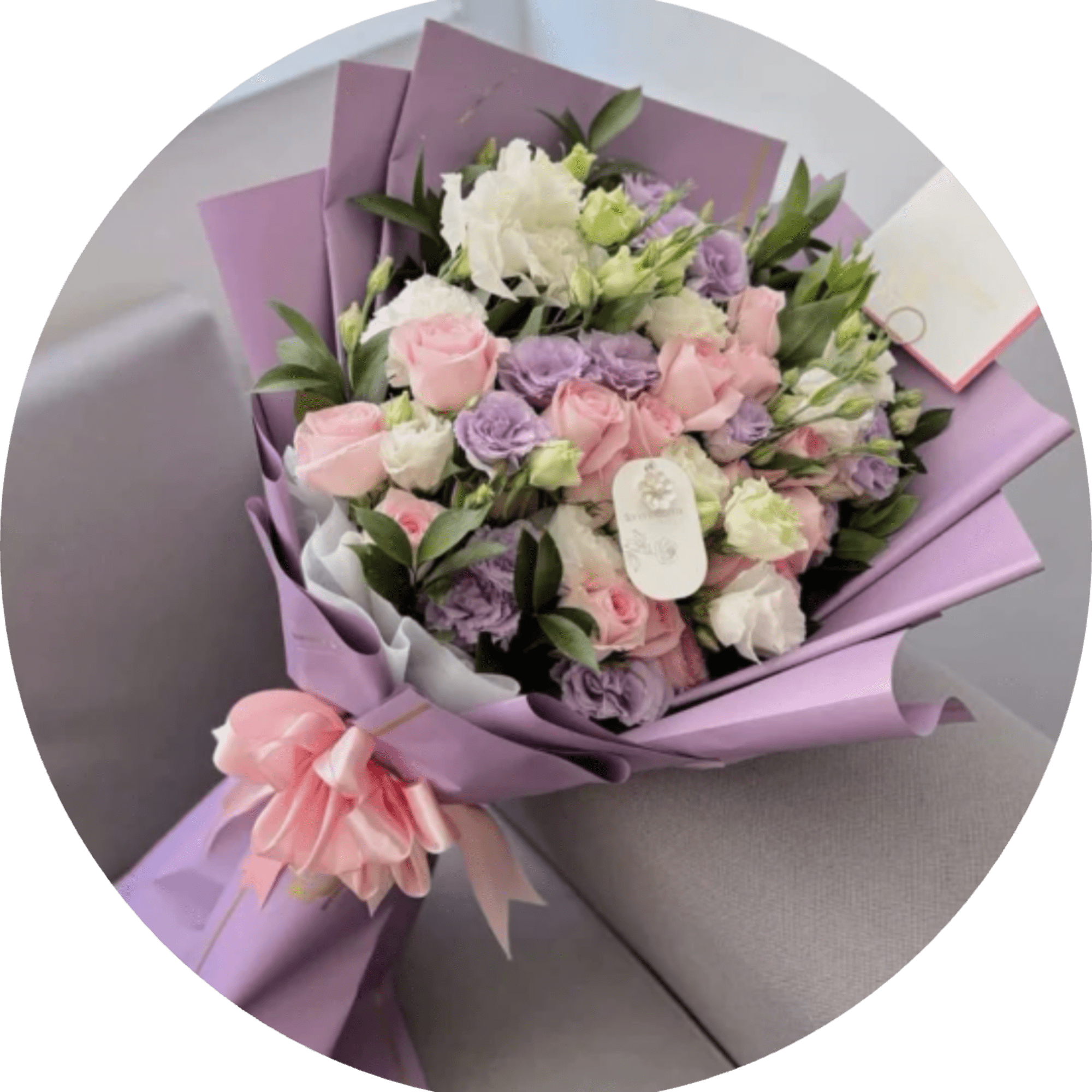 Lavender-toned blooms mingle with soft pink and creamy white roses in a