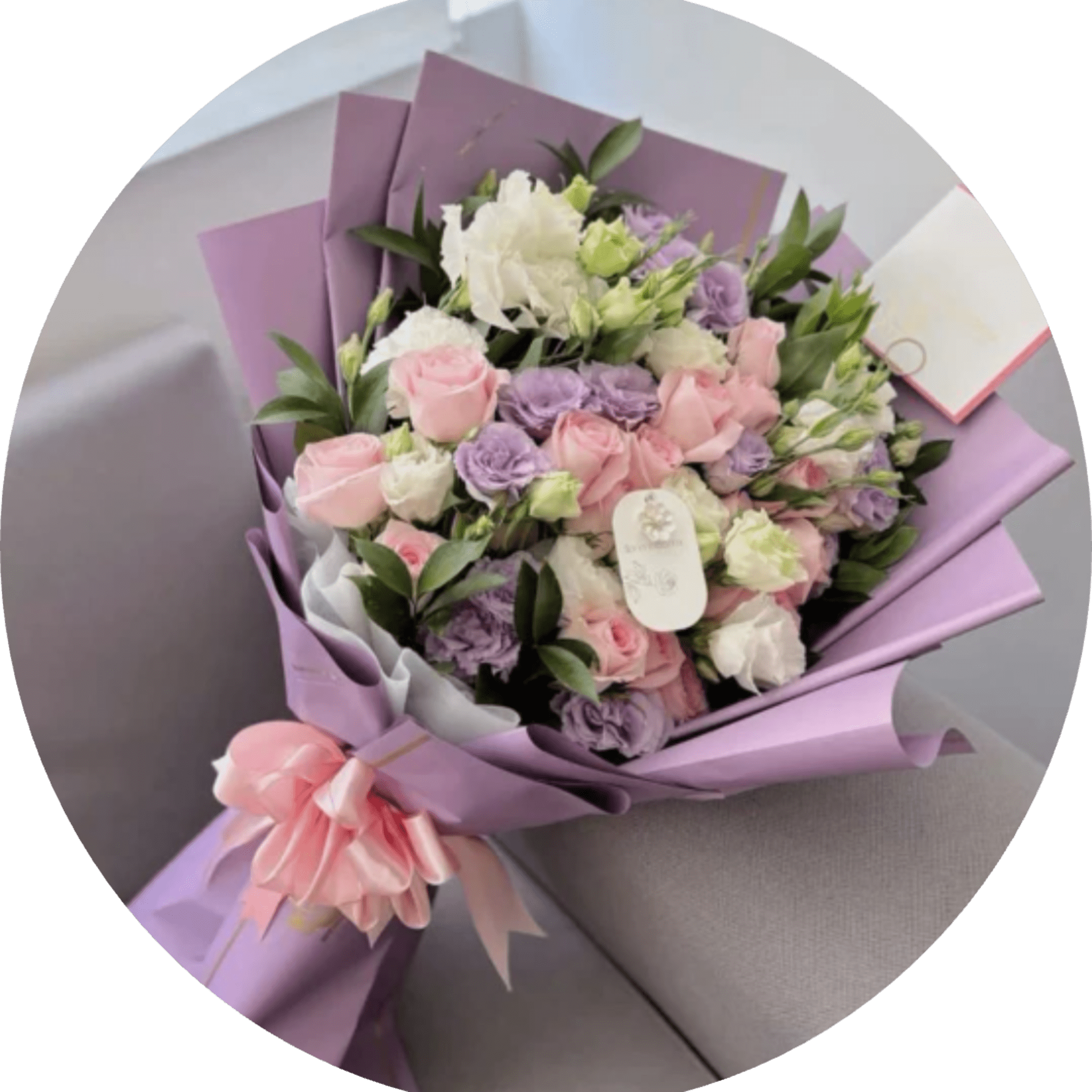 Lavender-toned blooms mingle with soft pink and creamy white roses in a