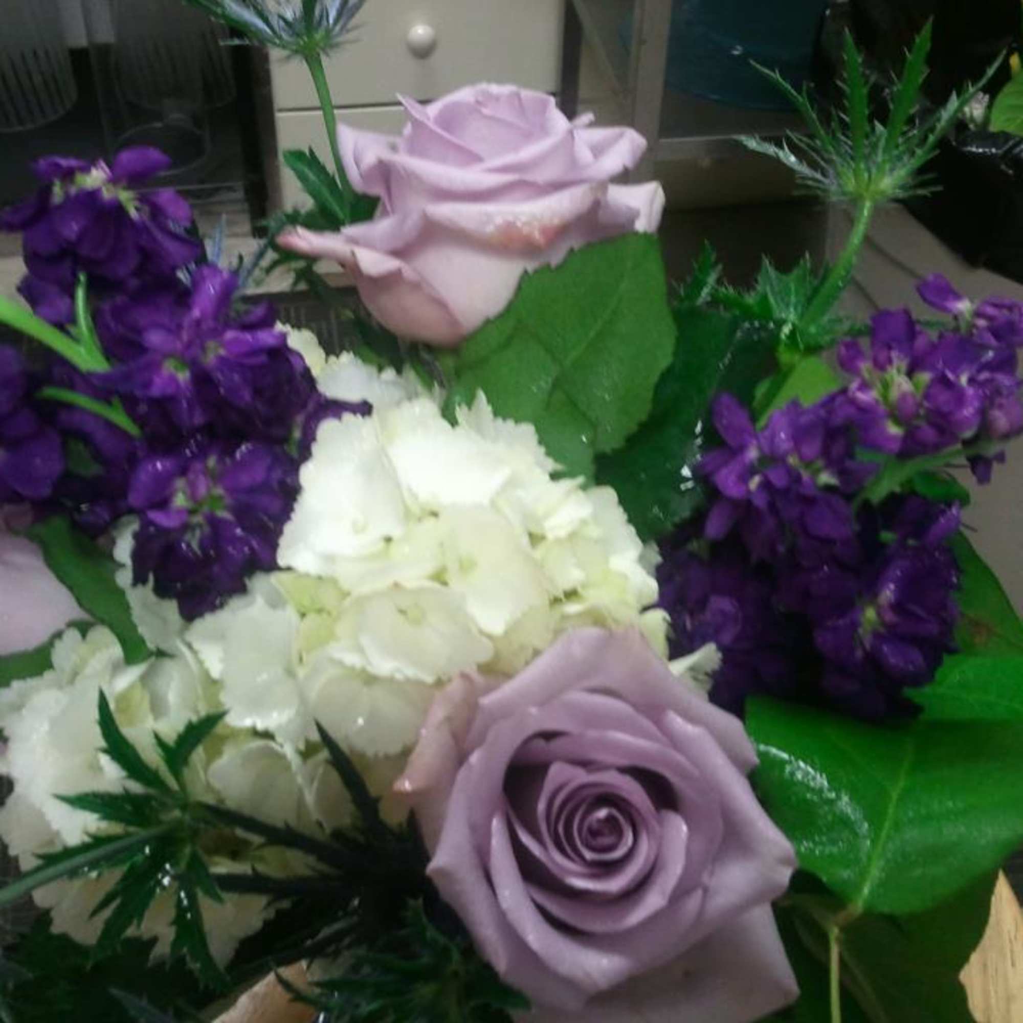 Lavender roses with white hydrangeas and purple flowers in a bouquet