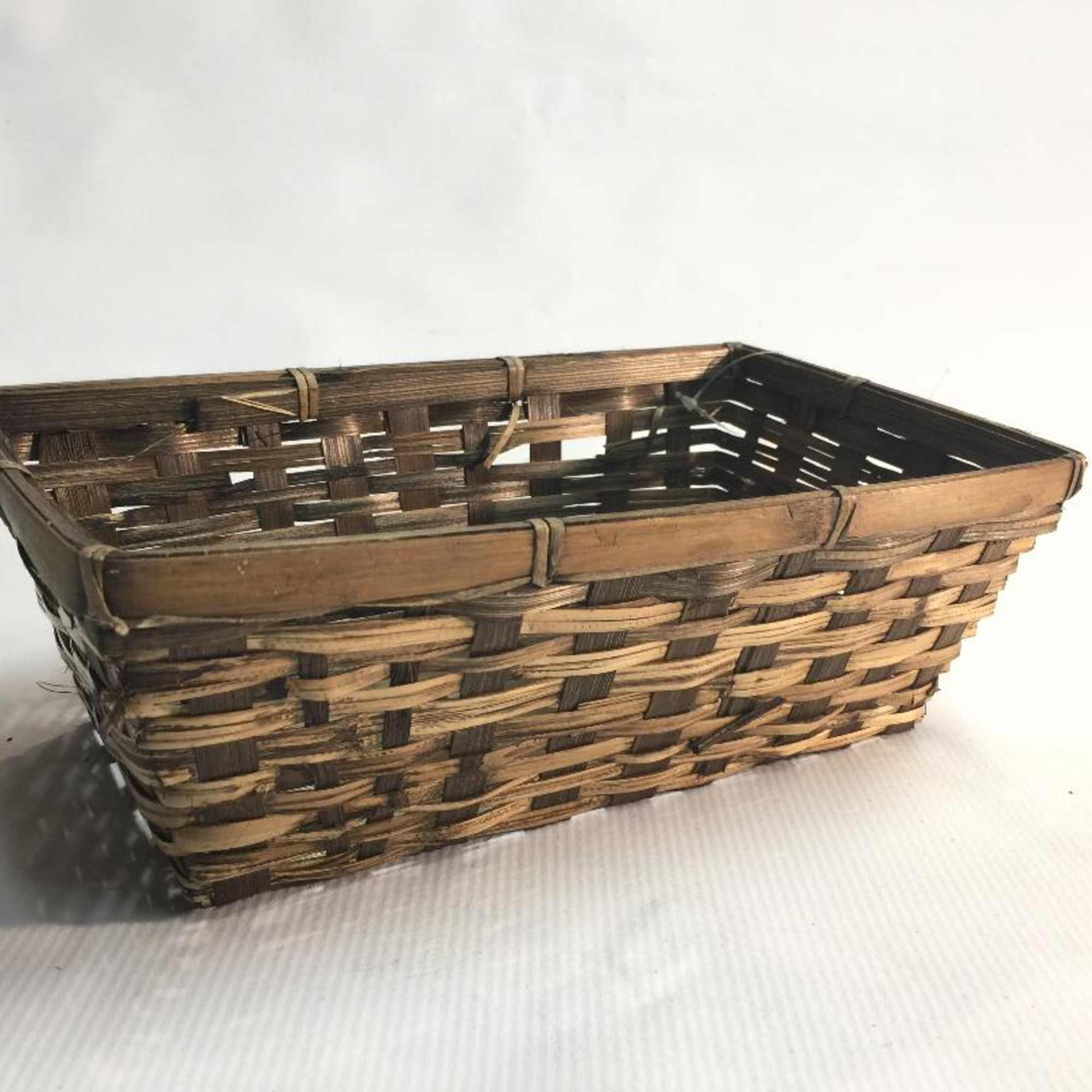 Rectangular woven basket with a dark and light brown pattern