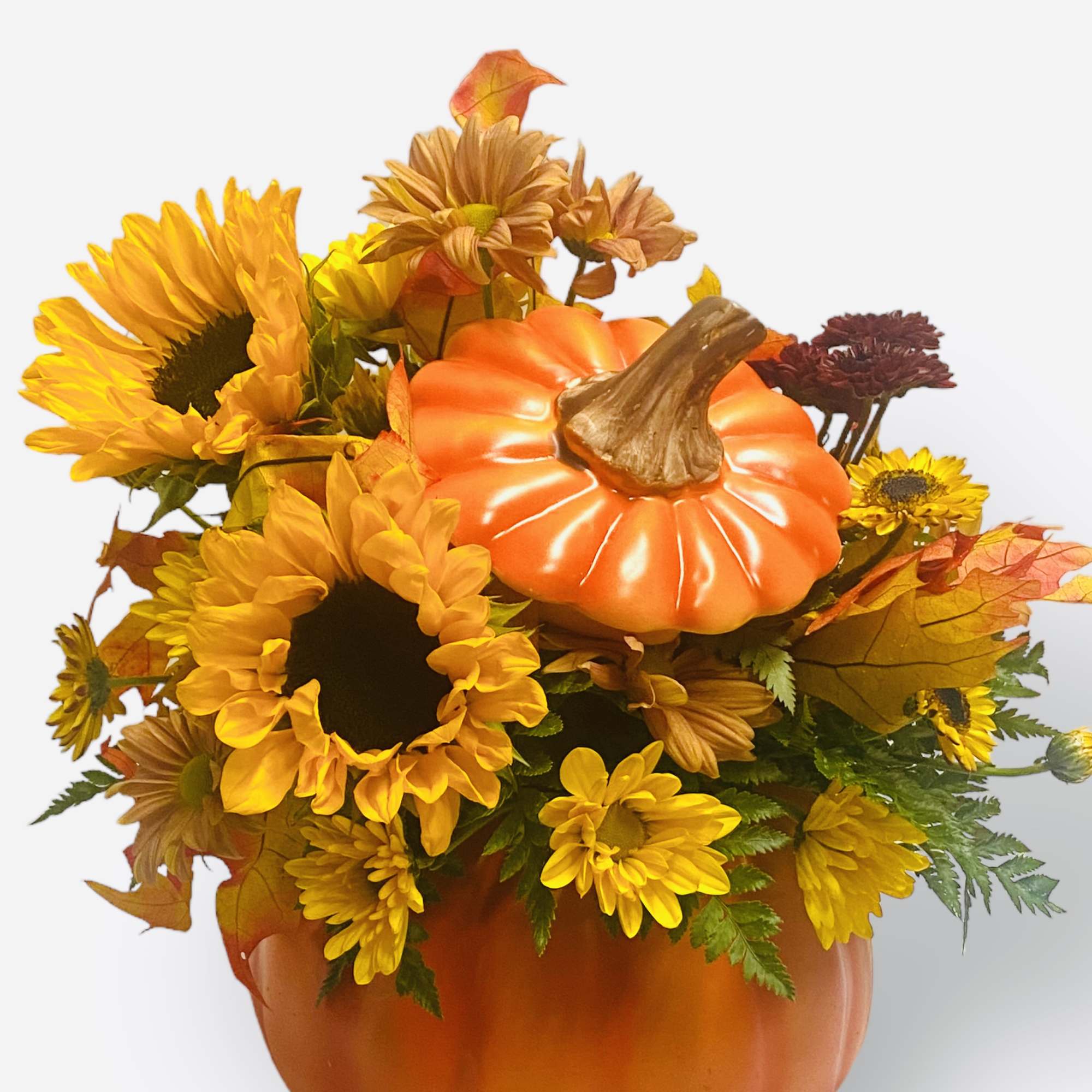 Pumpkin-shaped floral arrangement with sunflowers and autumn mums in an orange container