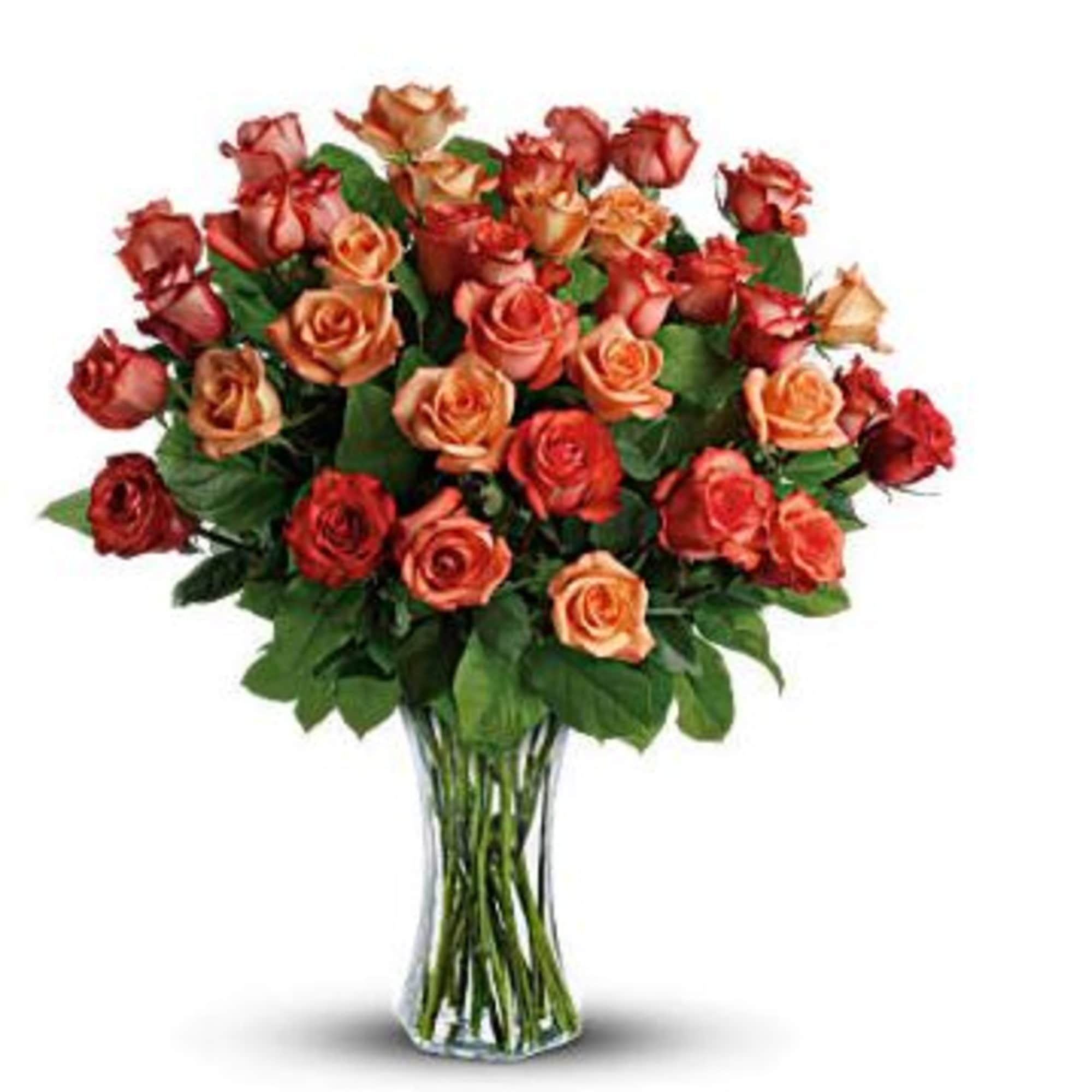Bouquet of red and peach roses in a clear glass vase