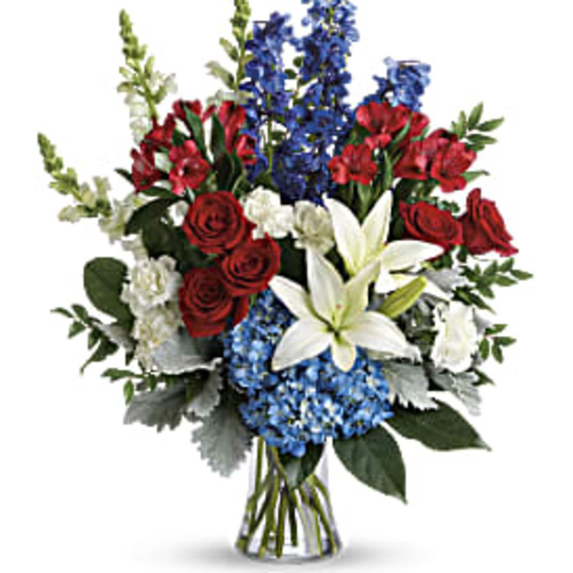 Bouquet of red roses, white lilies, and blue flowers in a glass vase