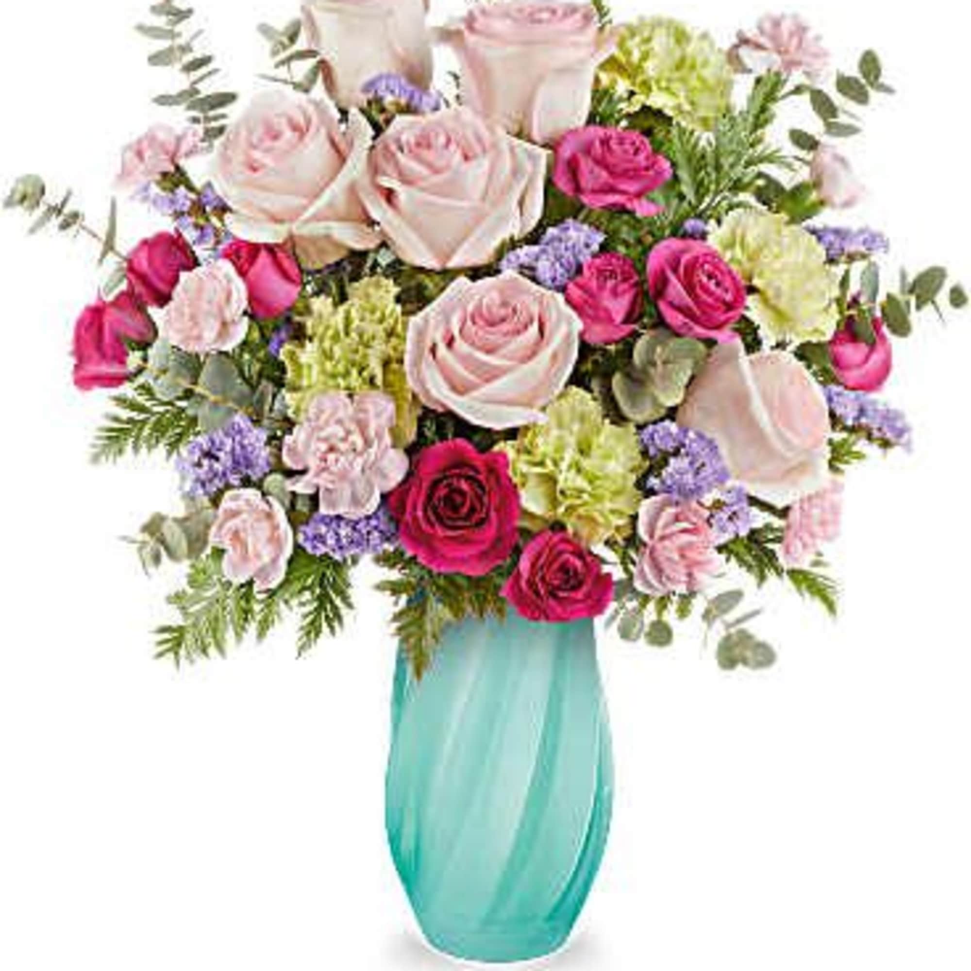 Bouquet of pink and white roses in a turquoise glass vase
