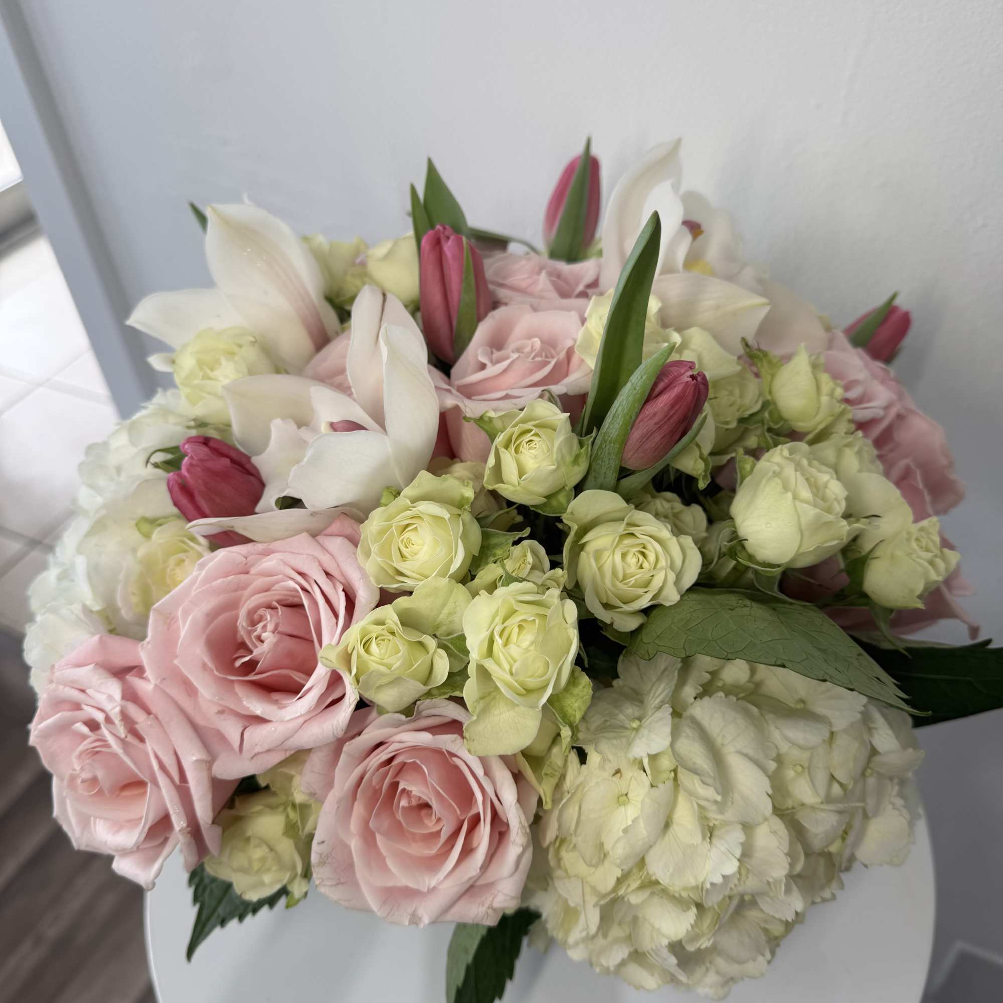 Bouquet of pink and white roses with lilies and hydrangea