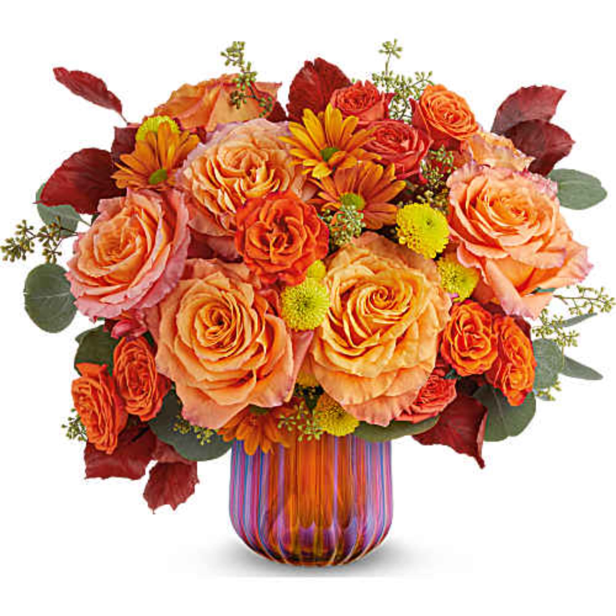 Orange and peach roses with yellow daisies in a striped glass vase