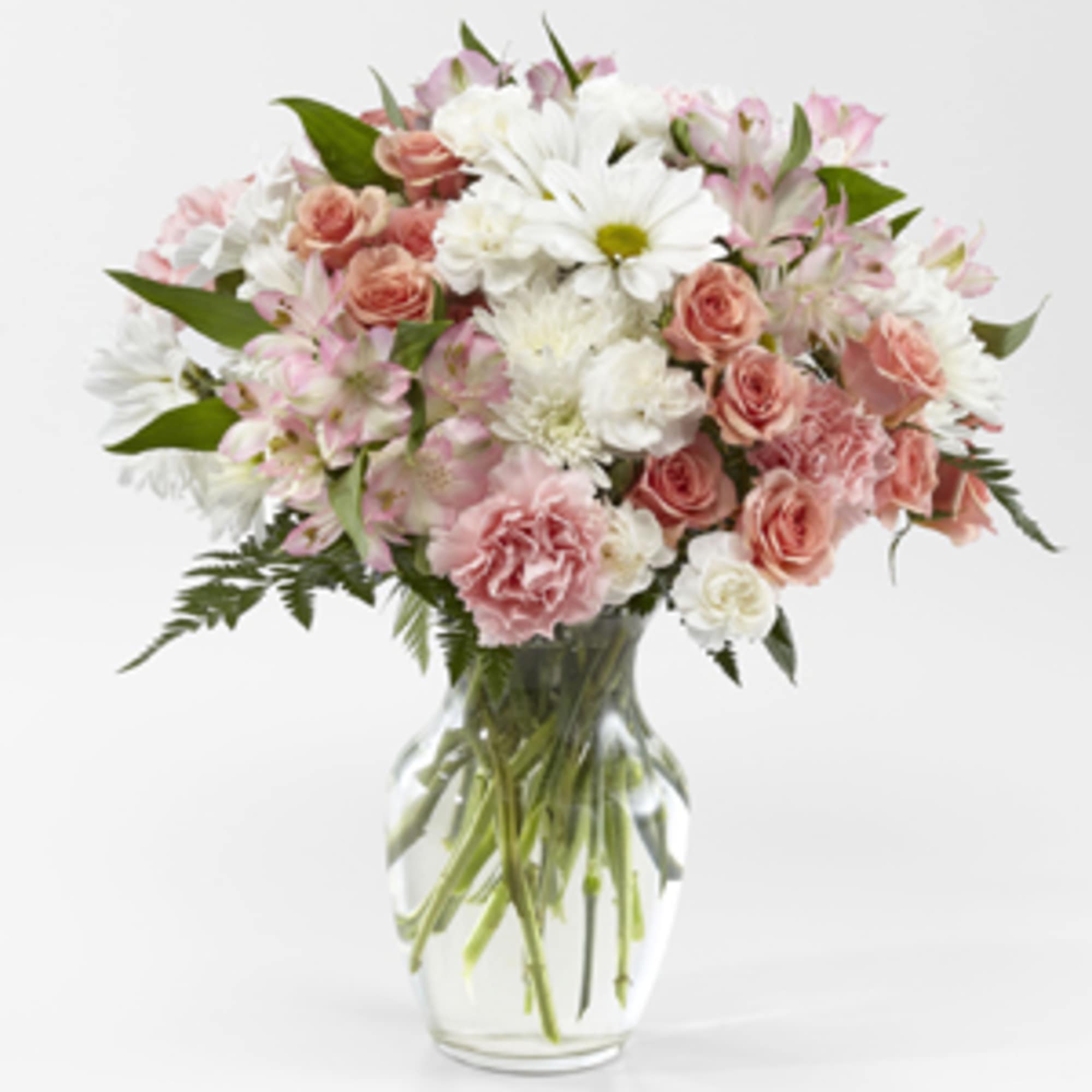 Pink and white mixed bouquet in a clear glass vase