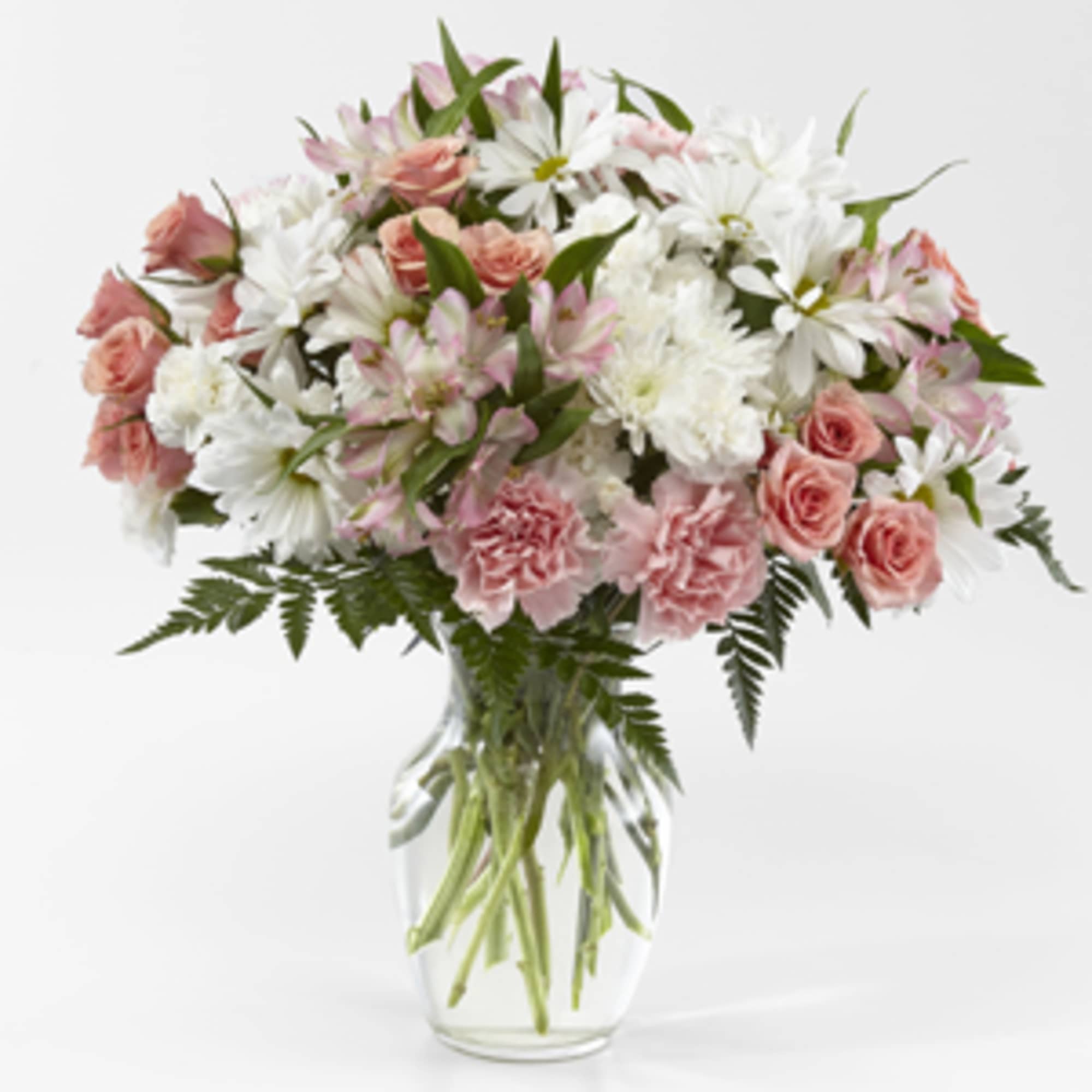 Pink and white mixed bouquet in a clear glass vase