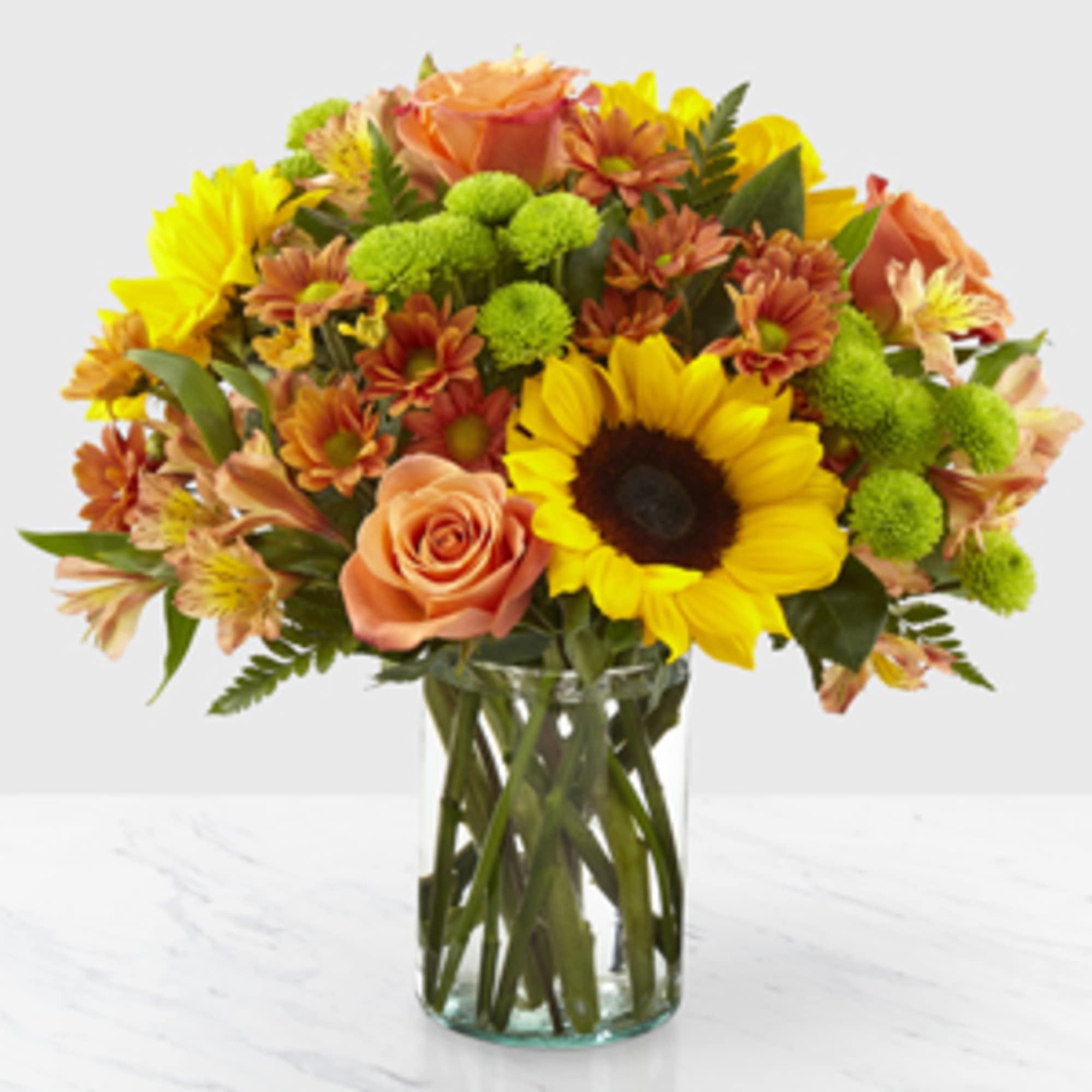 Sunflowers, roses, alstromeria, and mums make this bouquet a lively addition to