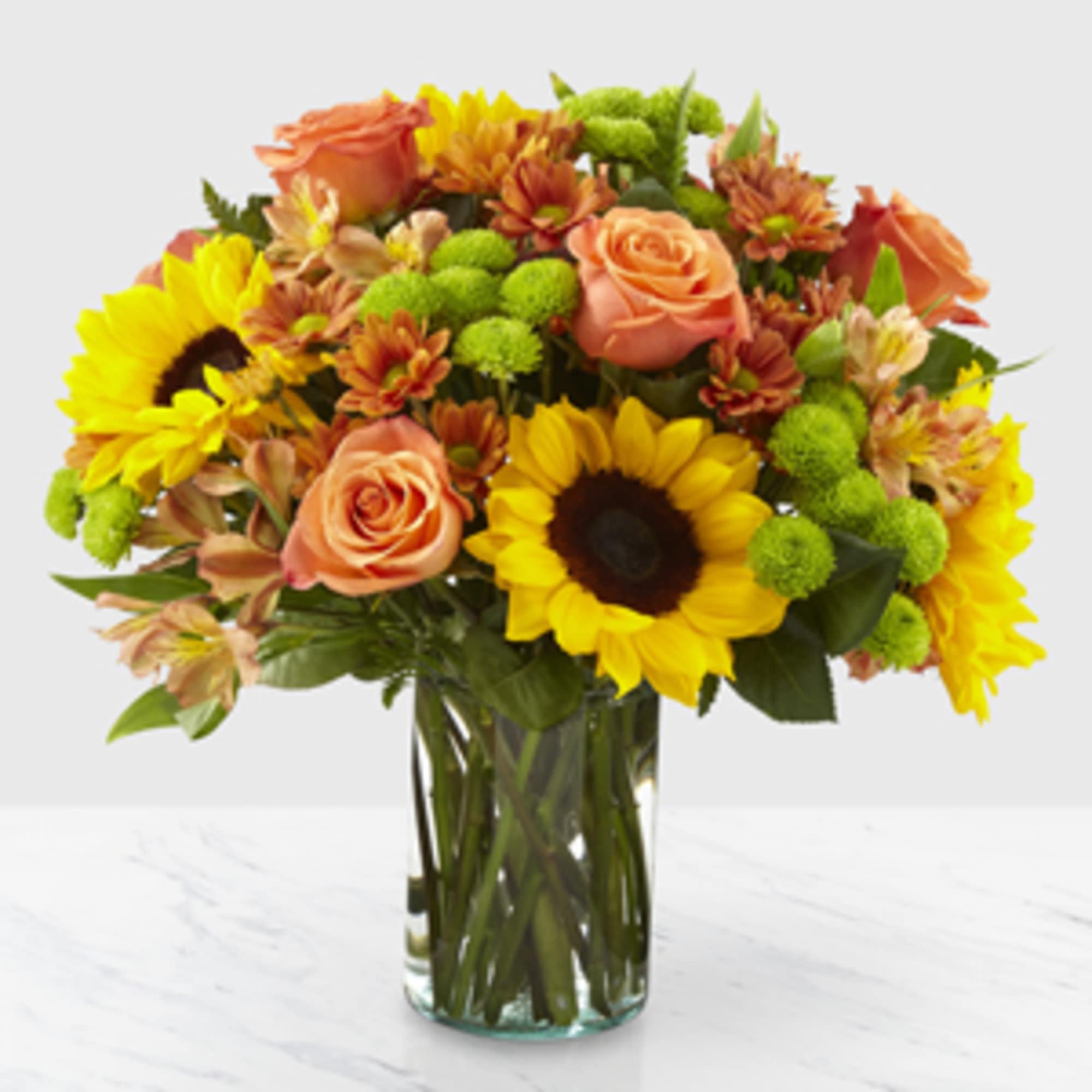 Sunflowers, roses, alstromeria, and mums make this bouquet a lively addition to