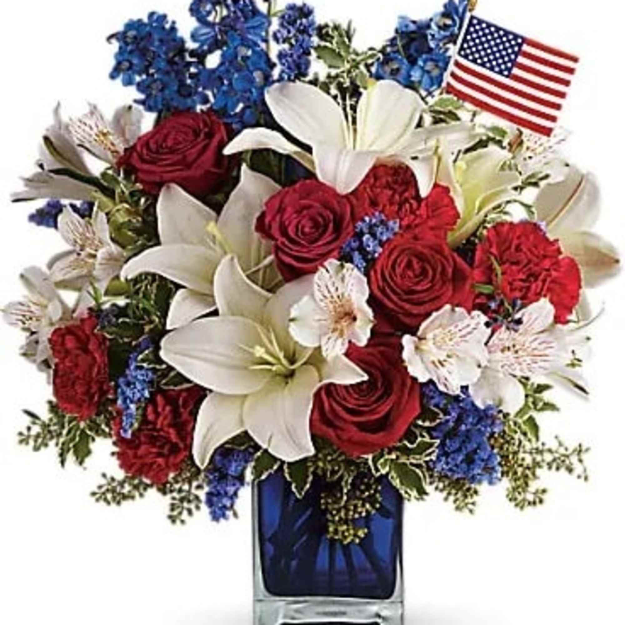 Red roses and white lilies in a blue vase with a small American flag