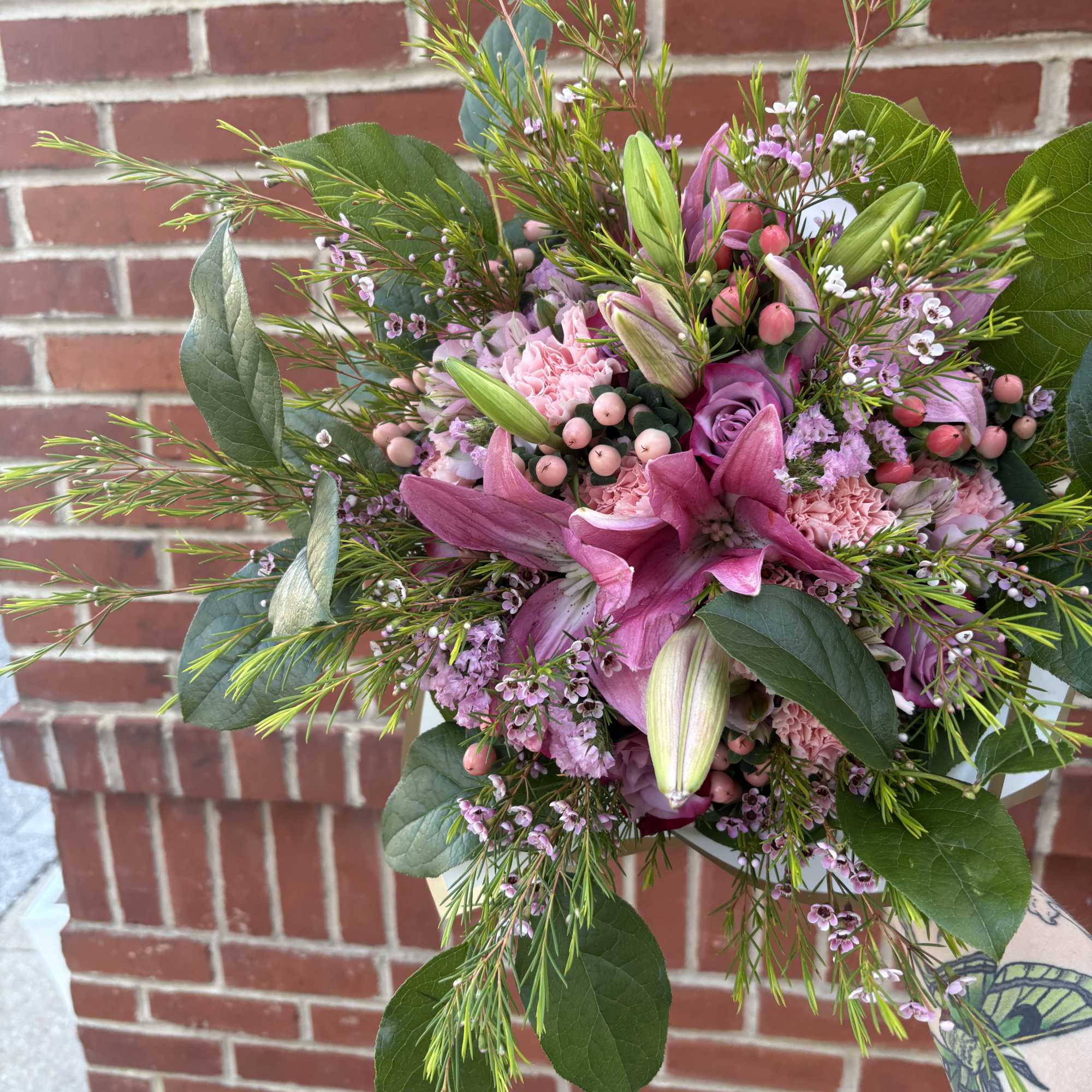 Pink lily and rose bouquet with greenery and small filler flowers