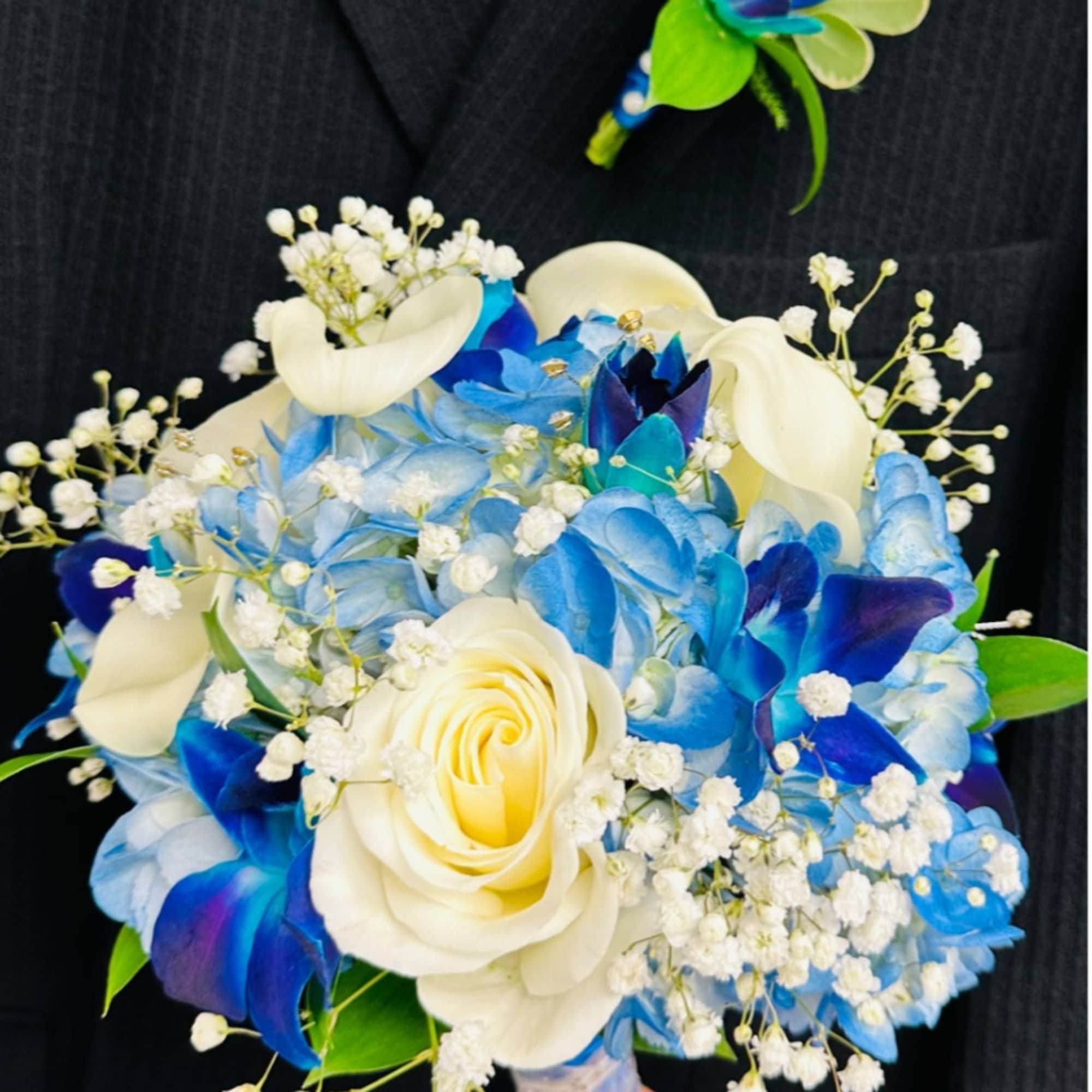 Blue and white bouquet with roses, hydrangeas, and calla lilies
