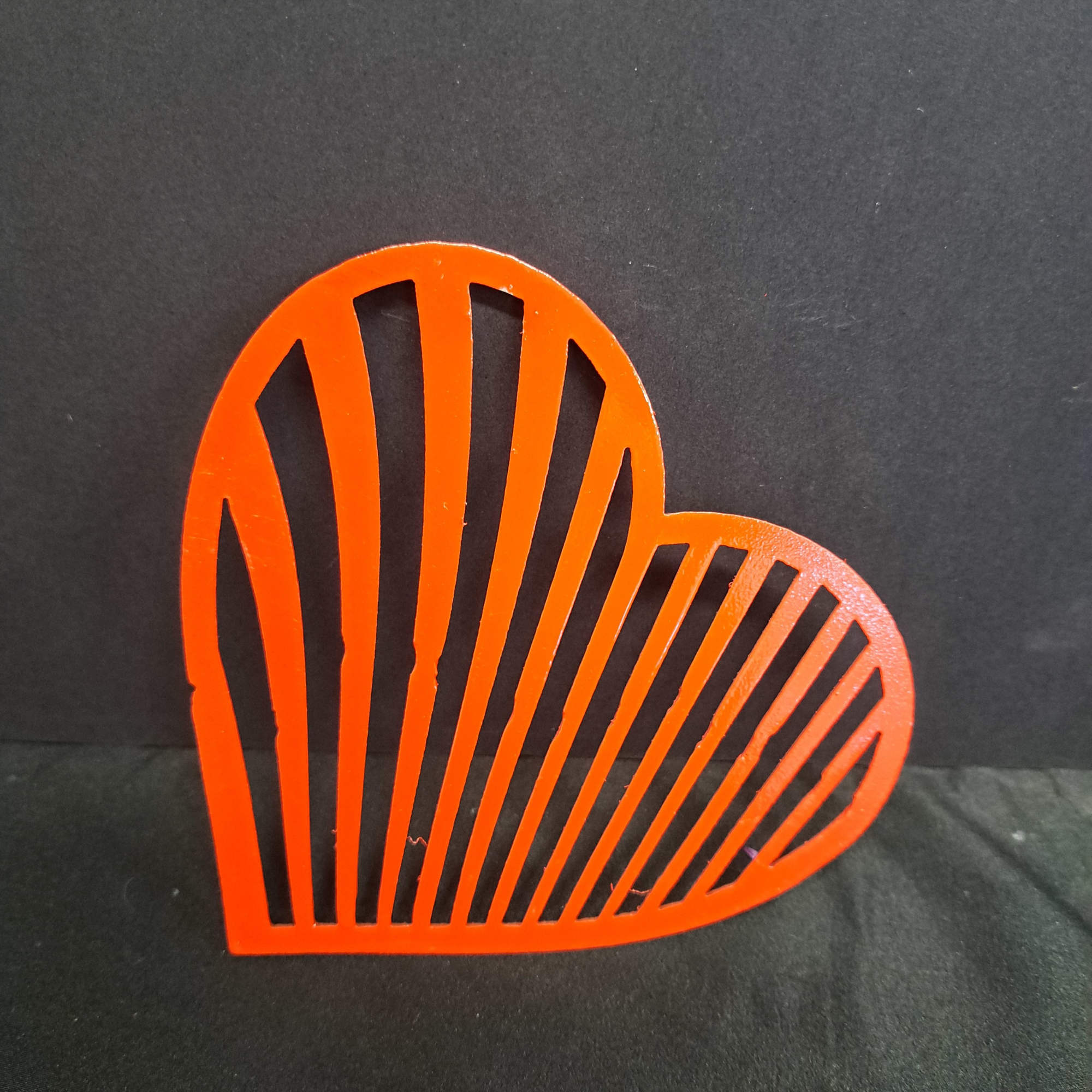 A hand-crafted metal heart wall hanger brings a graphic, romantic touch to, photo 2 of 2