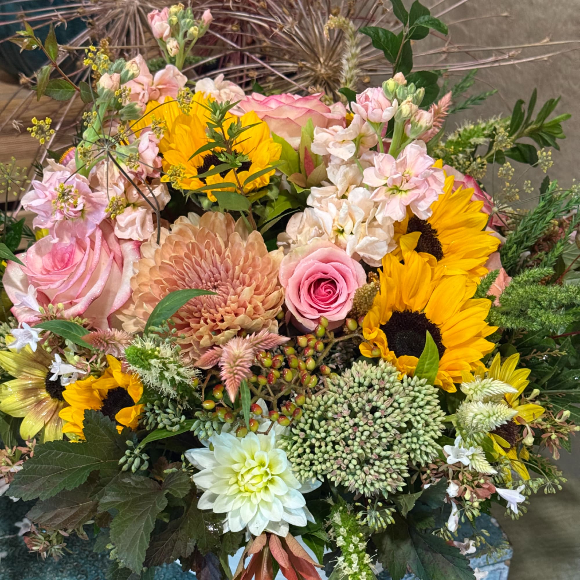 Mixed bouquet with pink roses, sunflowers, and chrysanthemums