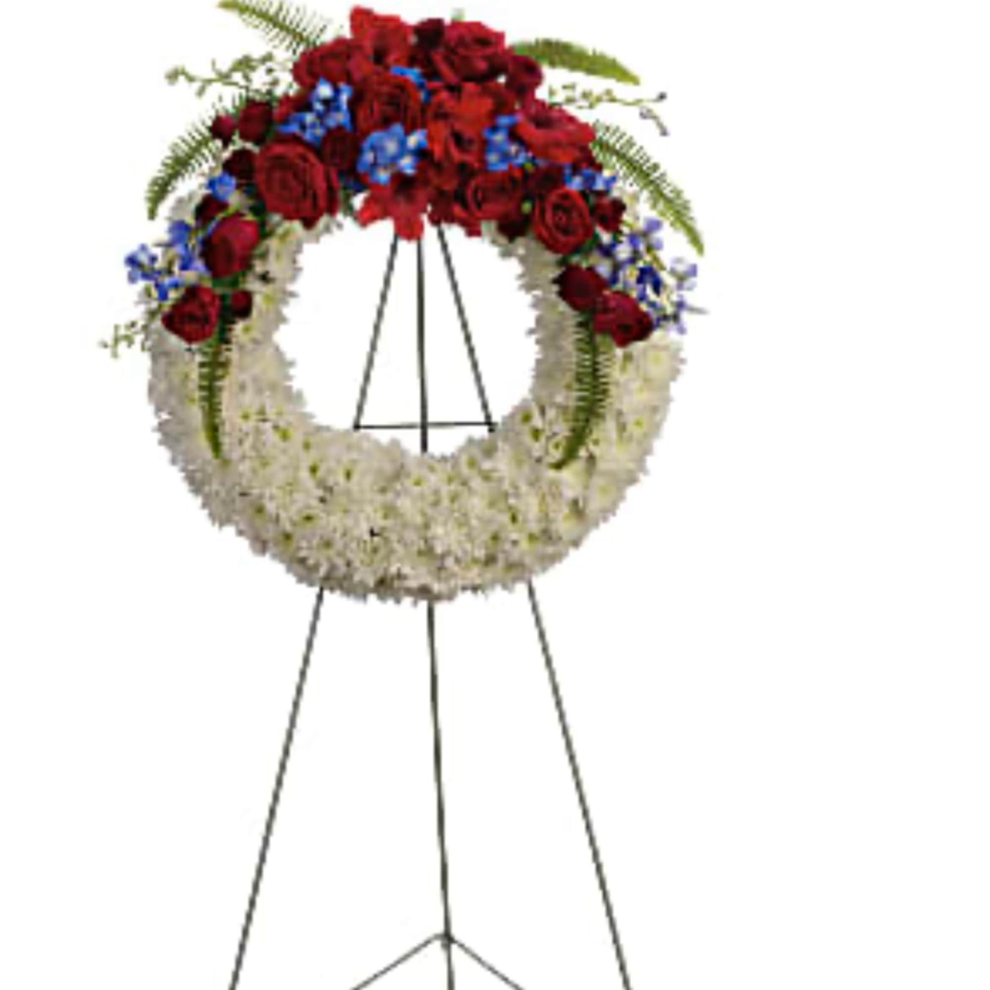 Standing funeral wreath with red and white flowers and blue accents