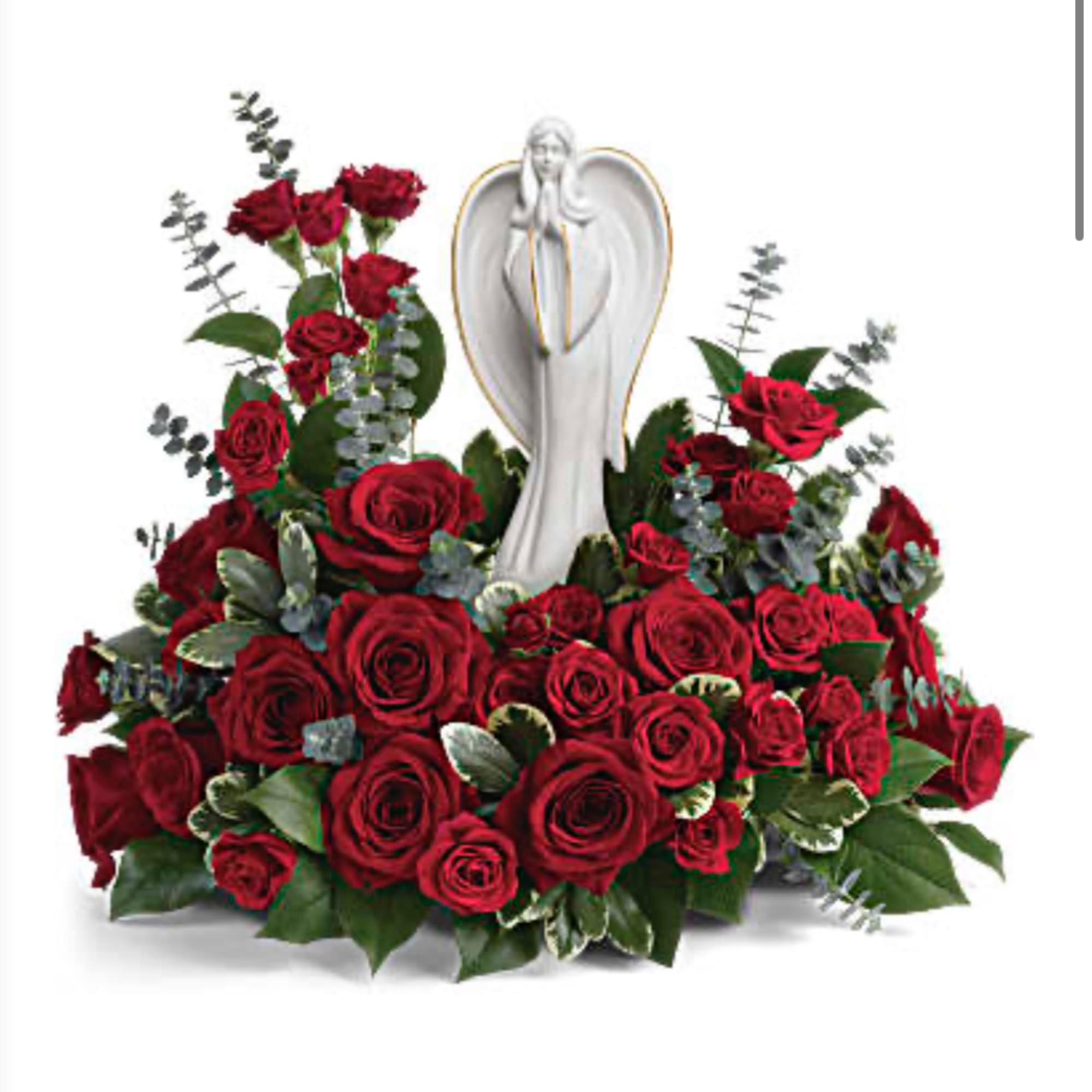 Red roses arranged around a white angel statue