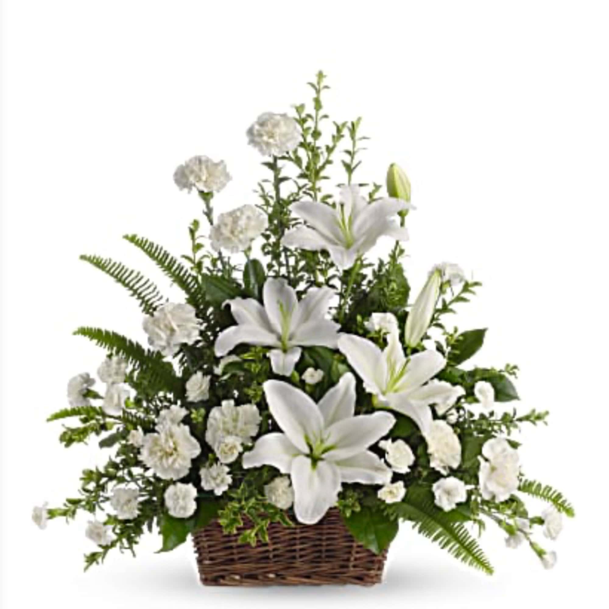 White lilies and carnations in a wicker basket