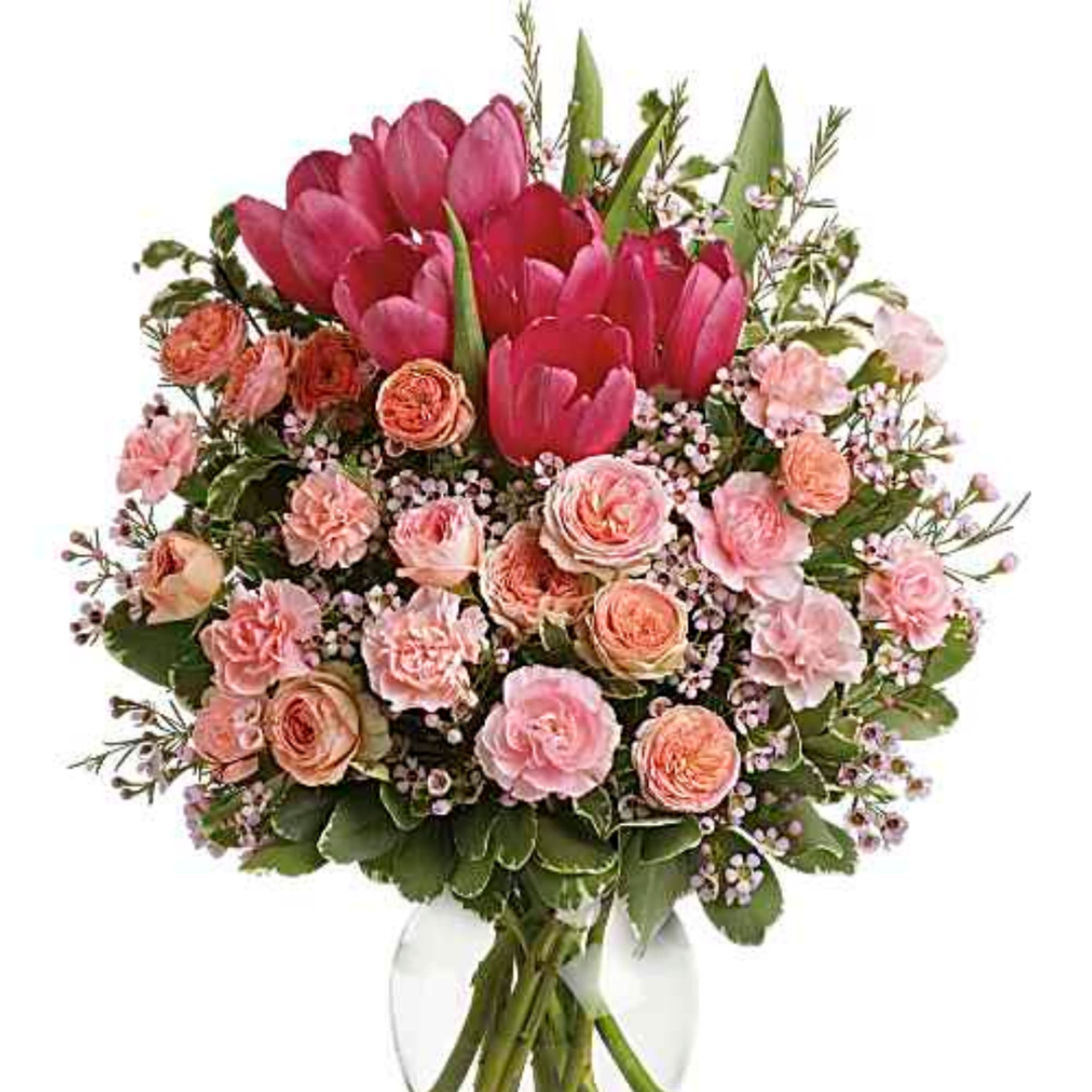 Pink tulips and peach roses in a clear glass vase
