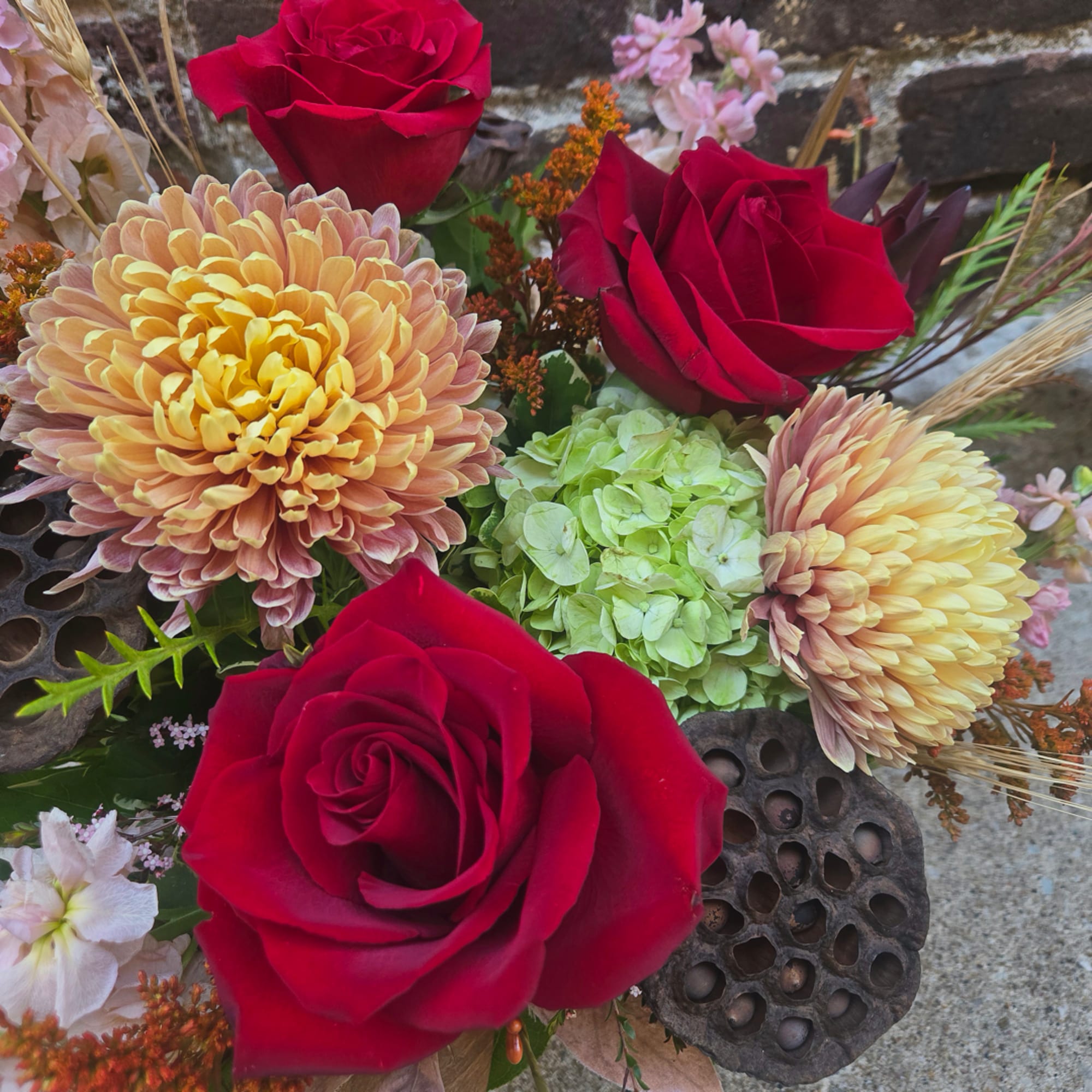 Bouquet of red roses, peach chrysanthemums, and green hydrangea