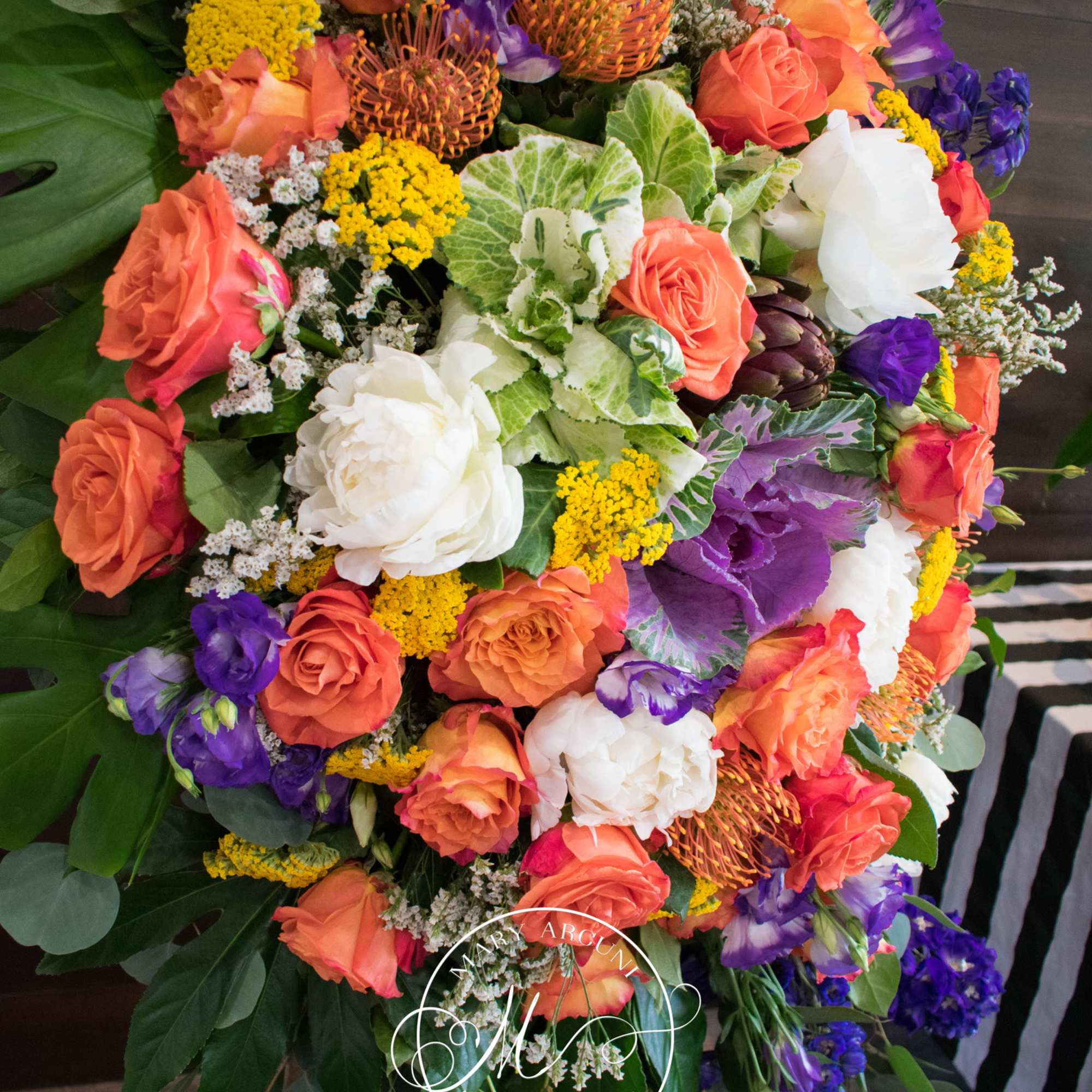 Large bouquet of orange, white, purple, and yellow flowers