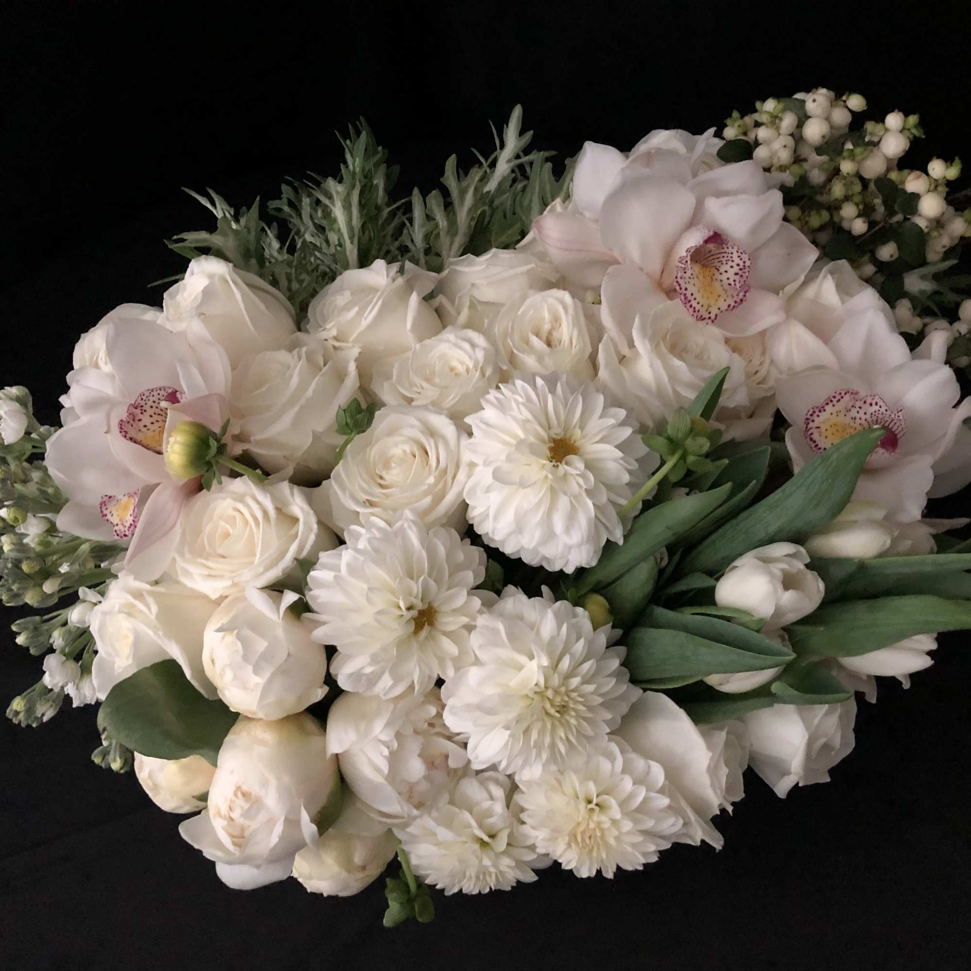 White bouquet with roses, orchids, and daisies