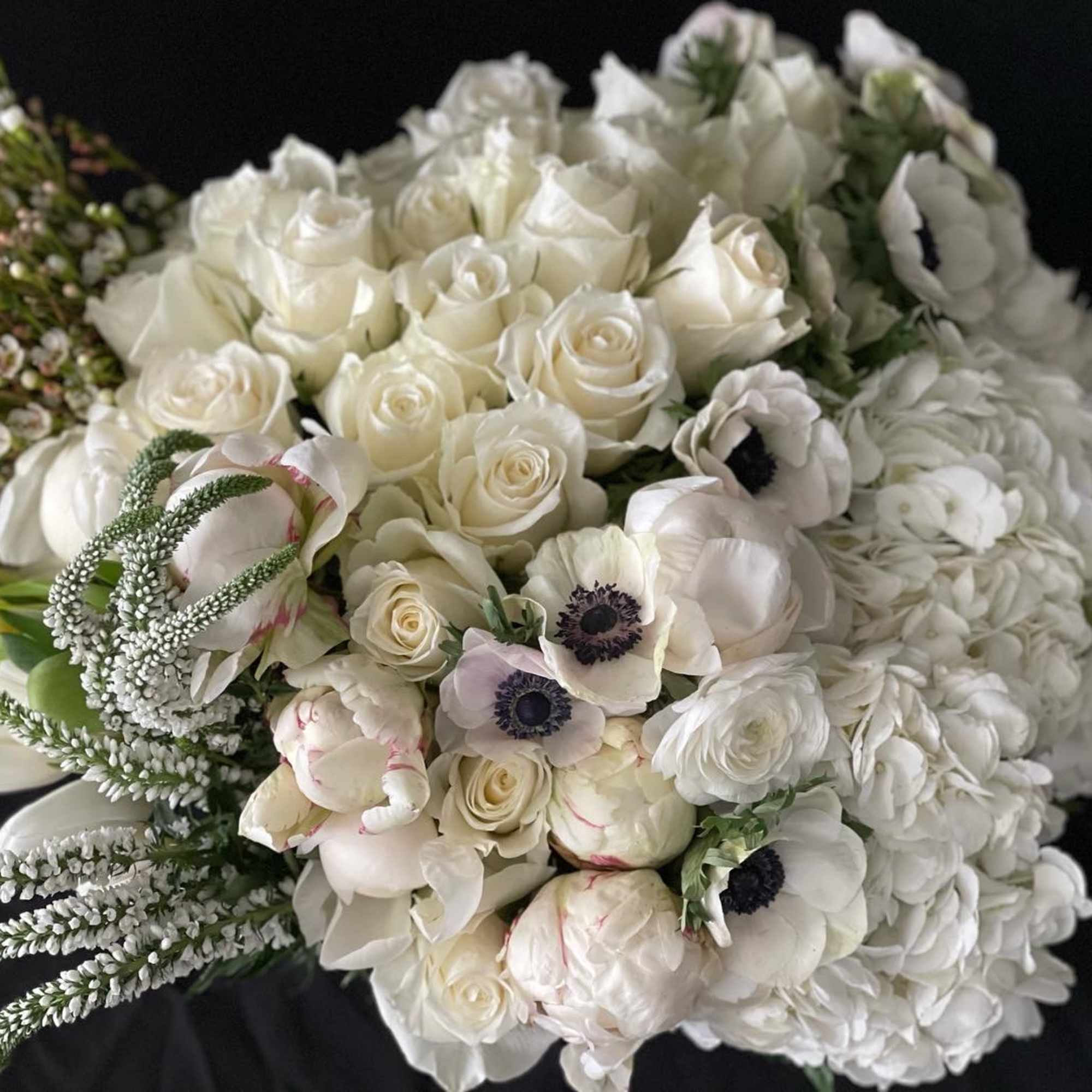 White bouquet with roses, anemones, and hydrangeas