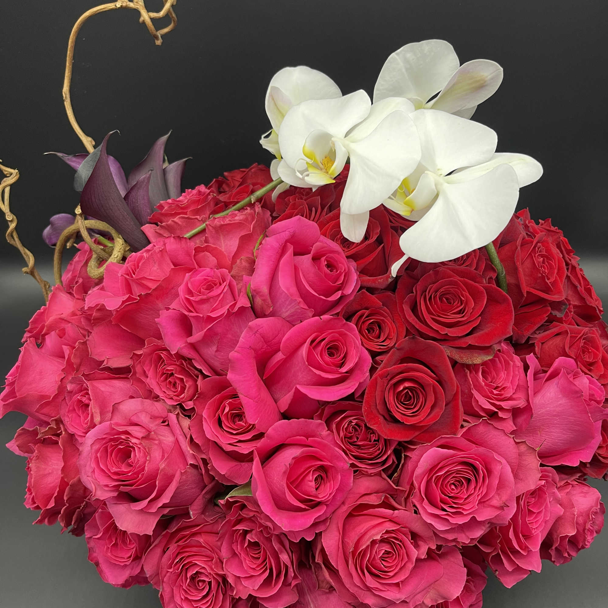 Pink and red rose bouquet with white orchids
