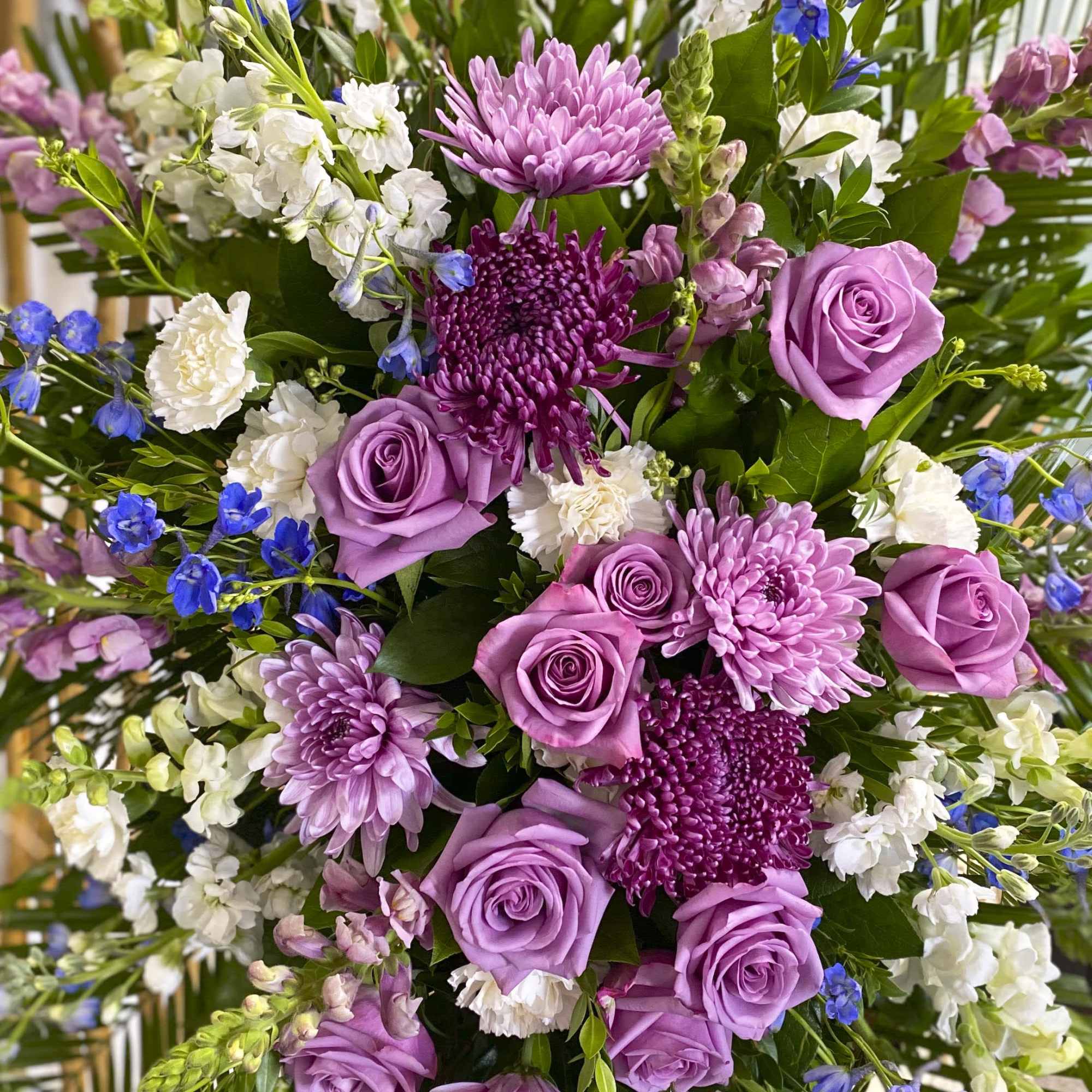 Bouquet of lavender roses and purple chrysanthemums with white filler flowers