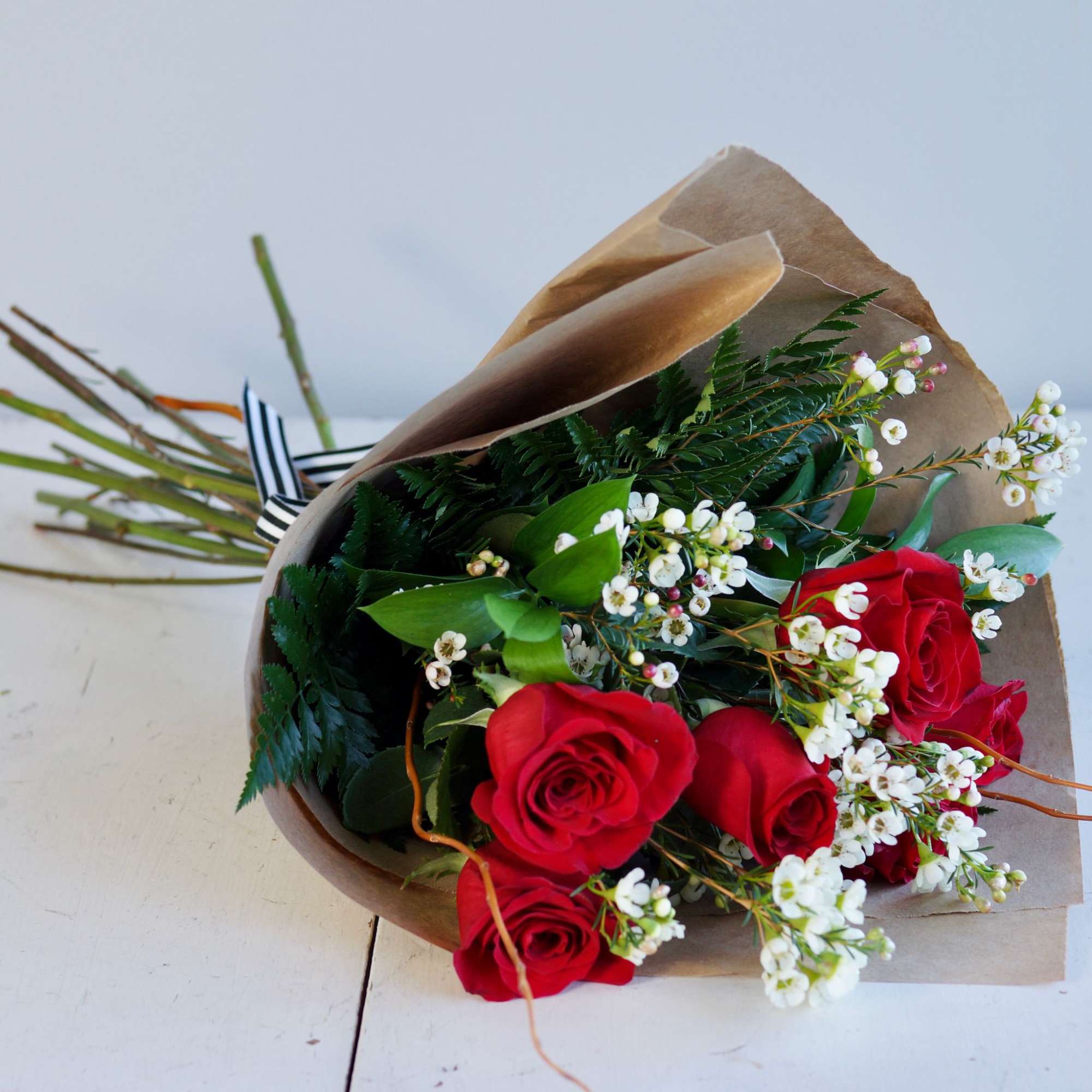 Beautiful Roses wrapped with beautiful filler and greenery 