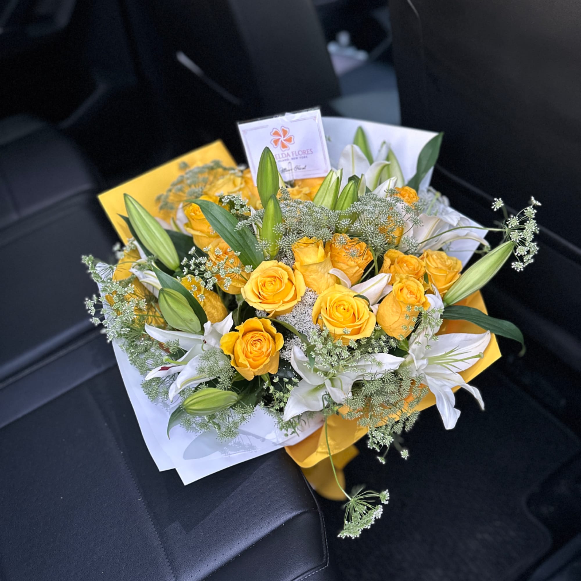 Yellow roses and white lilies in wrapped bouquet, photo 2 of 3